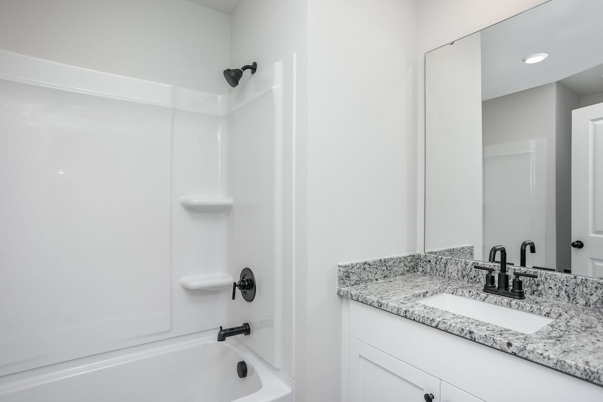 The secondary bathroom has a large soaking tub