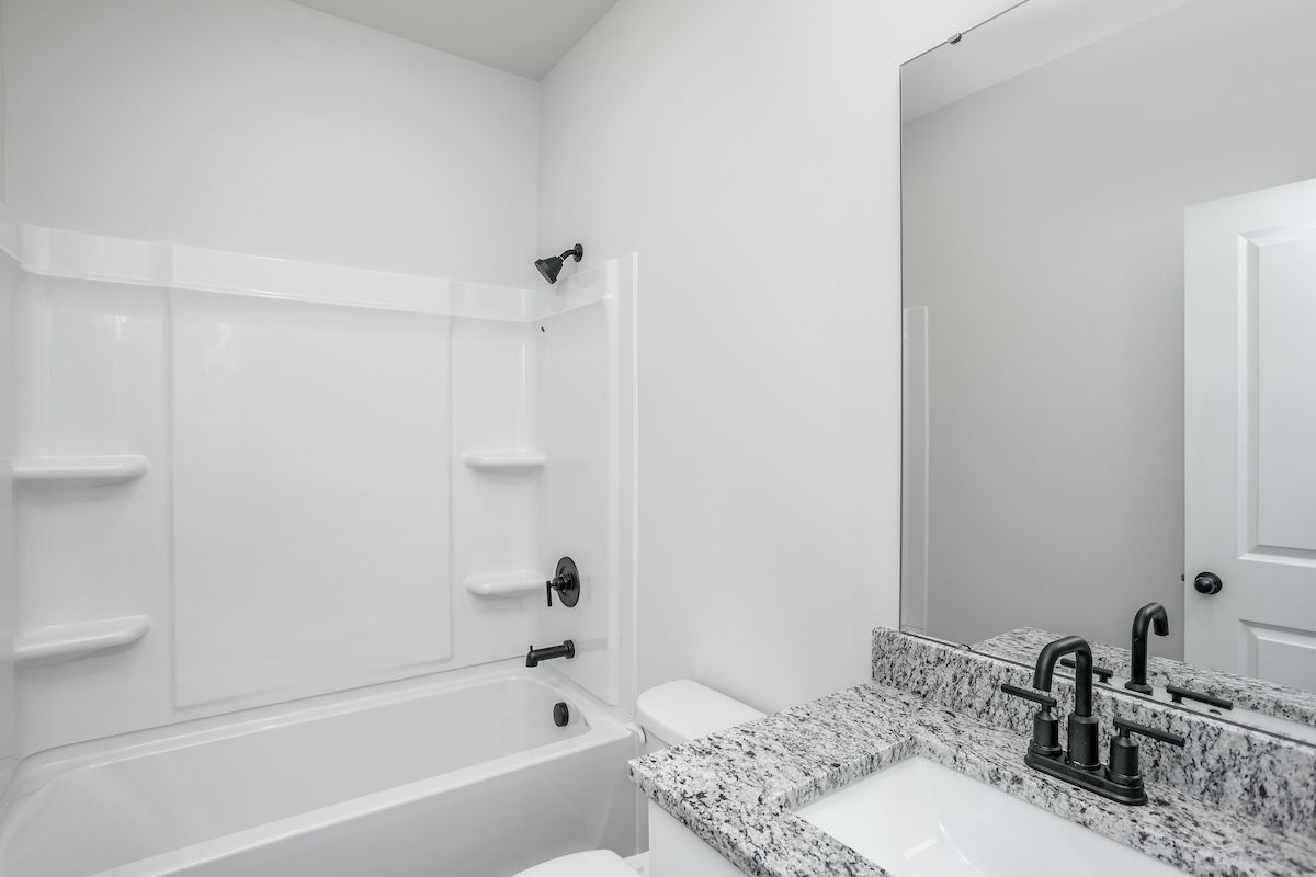 The secondary bathroom has a large soaking tub
