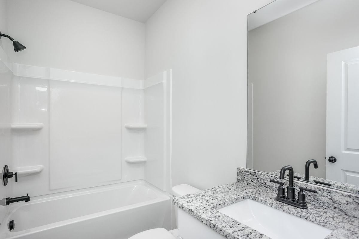 The secondary bathroom has a large soaking tub