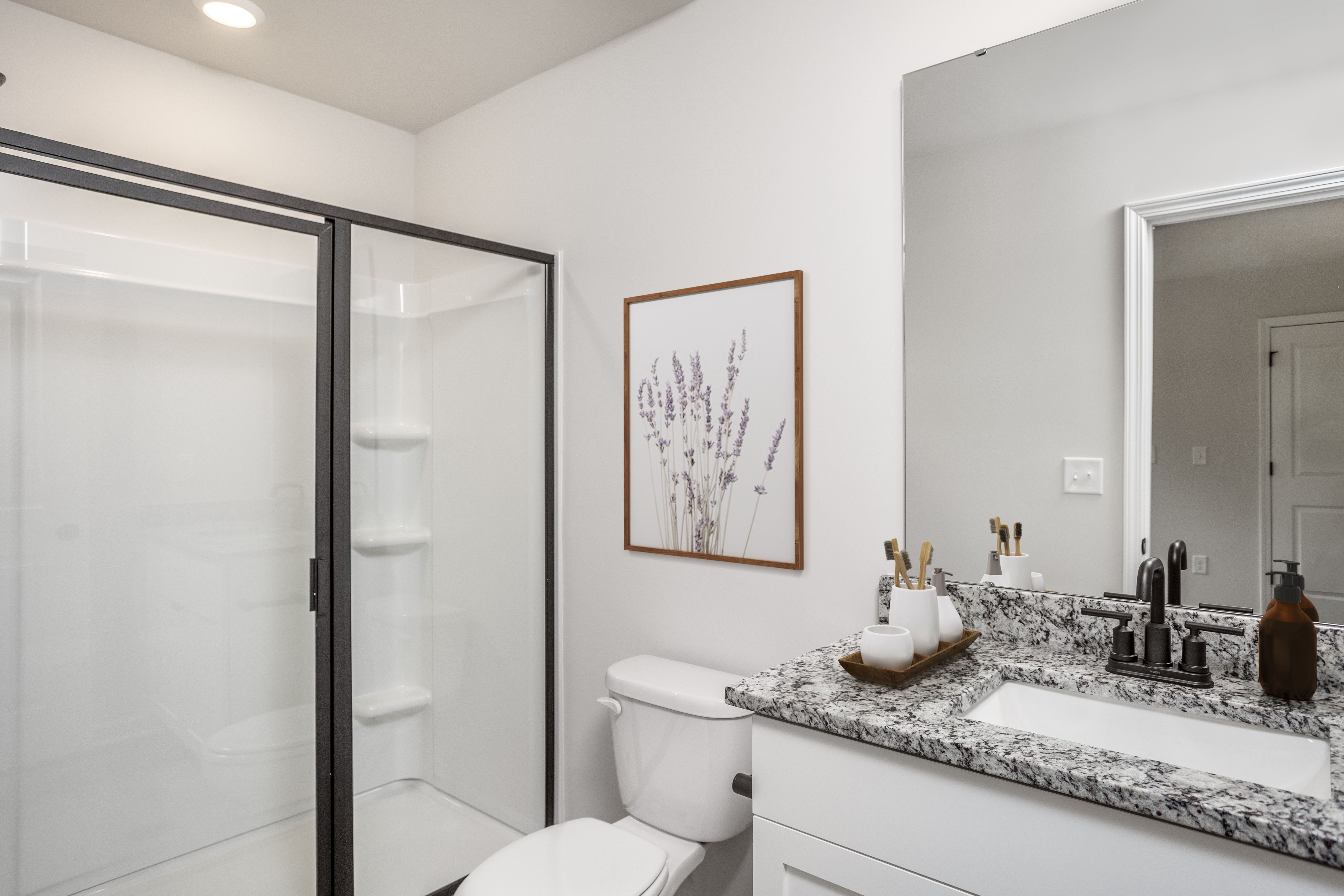 This bathroom has a glass-enclosed shower