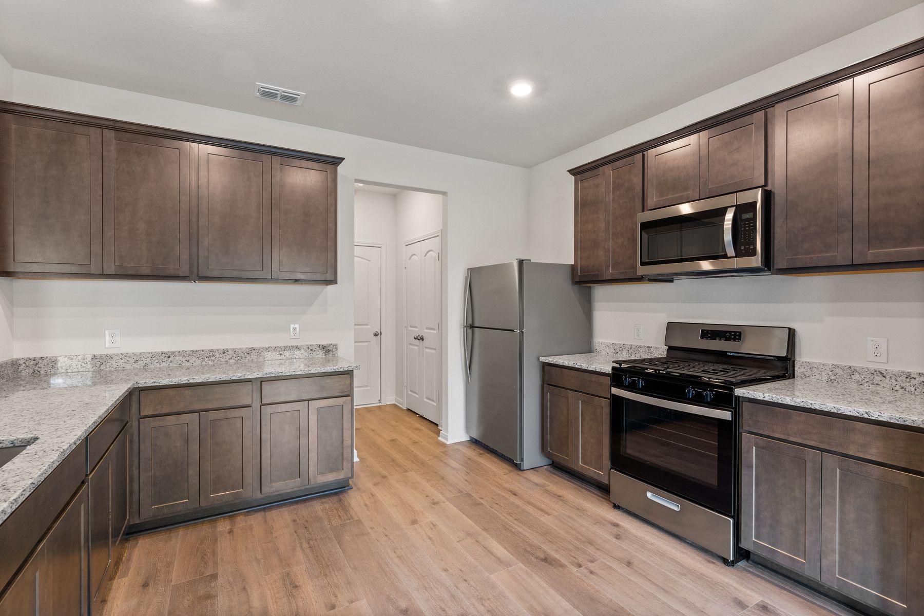 The kitchen has gorgeous wood cabinetry.