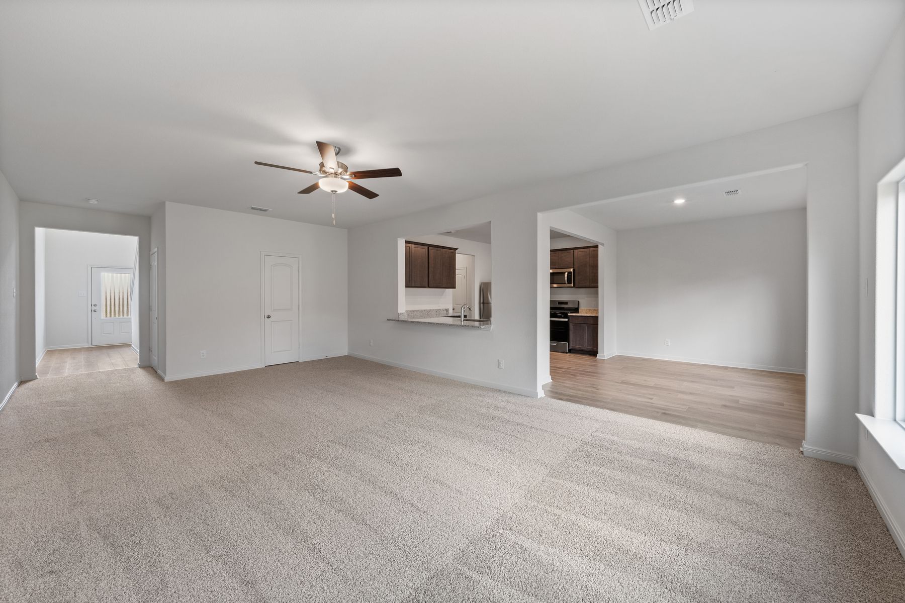 The open layout connects the family room with the kitchen and dining room.
