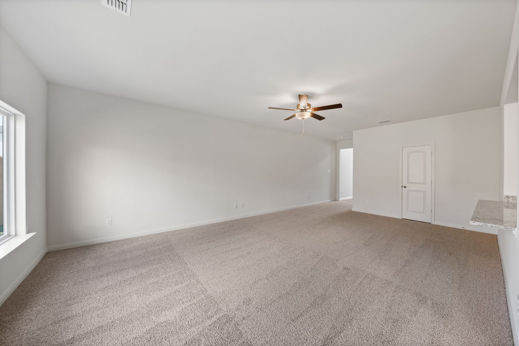 The spacious family room is perfect for family living and hosting.