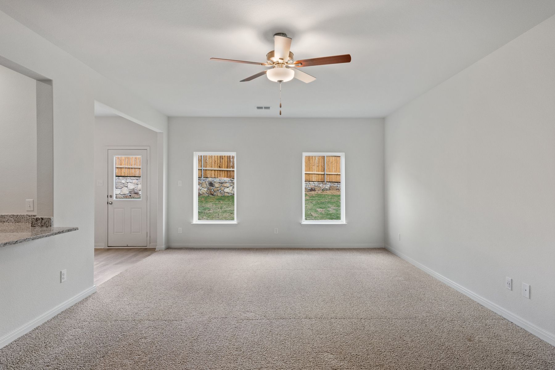 The spacious family room has large windows that let in great natural light and backyard views.