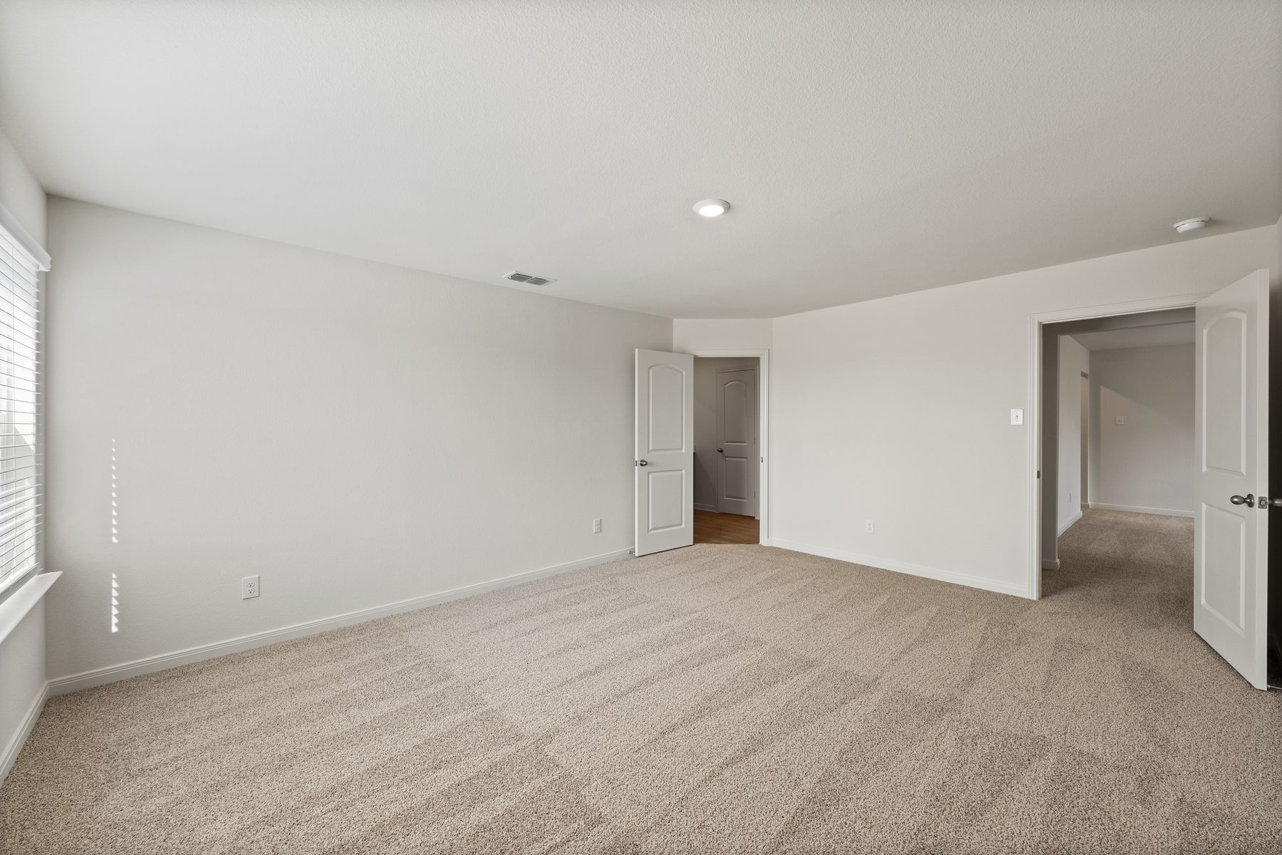The master suite has a spacious bedroom, en-suite bathroom and walk-in closet.