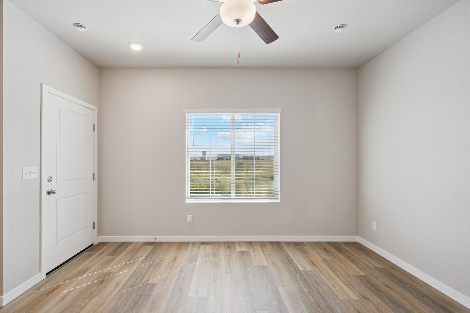 The family room is spacious with a ceiling fan.