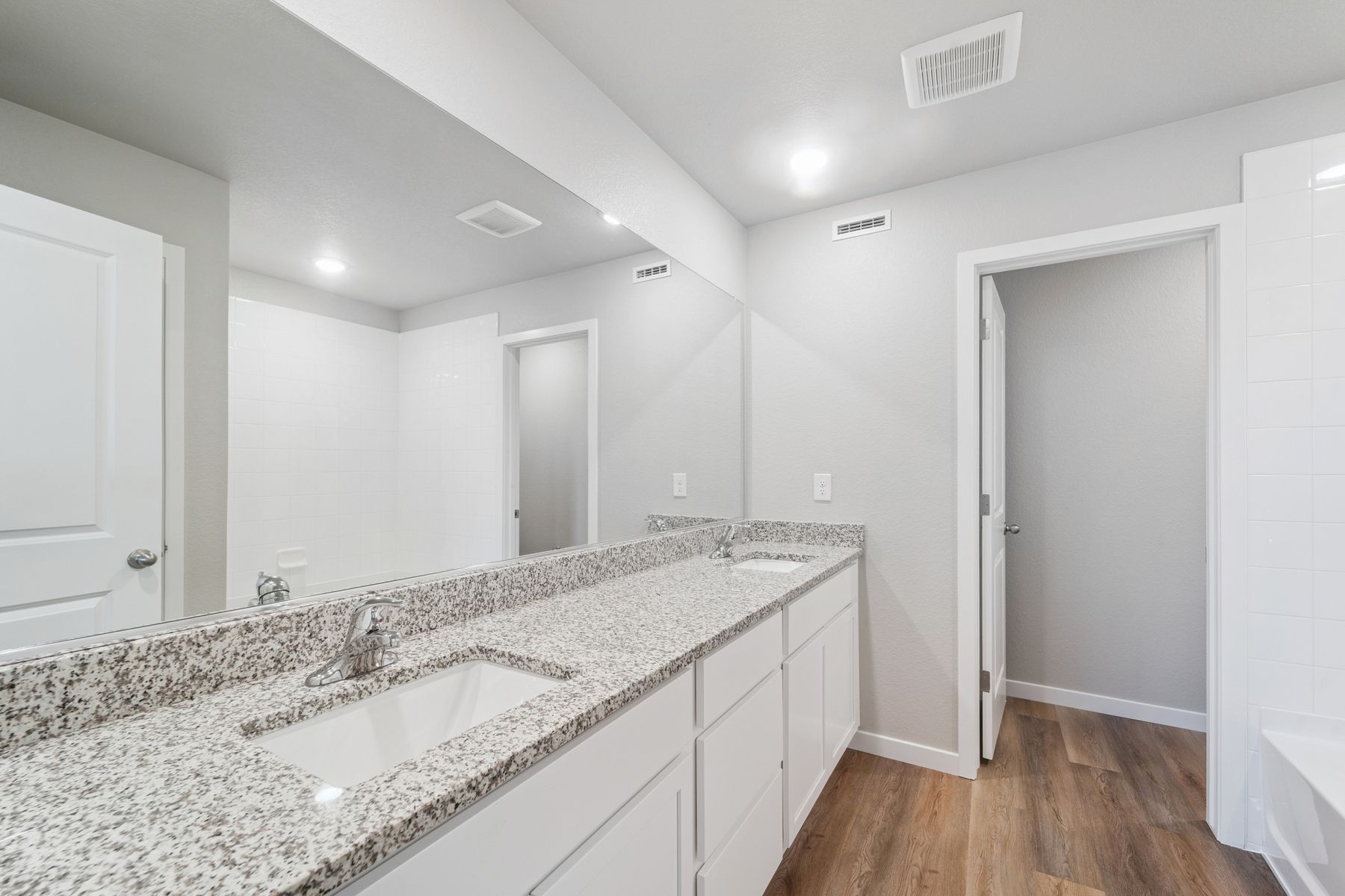 The master bathroom has a dual sink vanity.