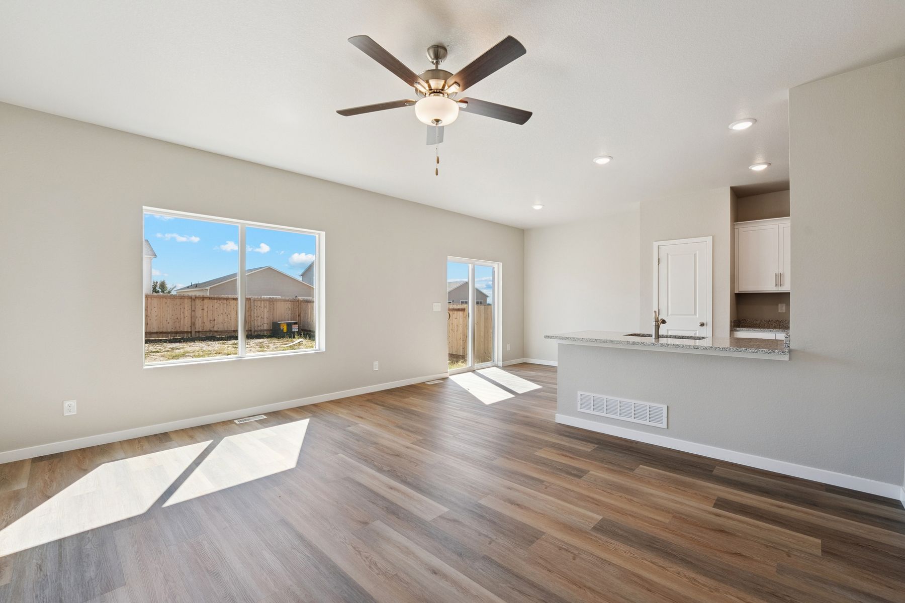 Open layout with the kitchen overlooking the living room and dining area.