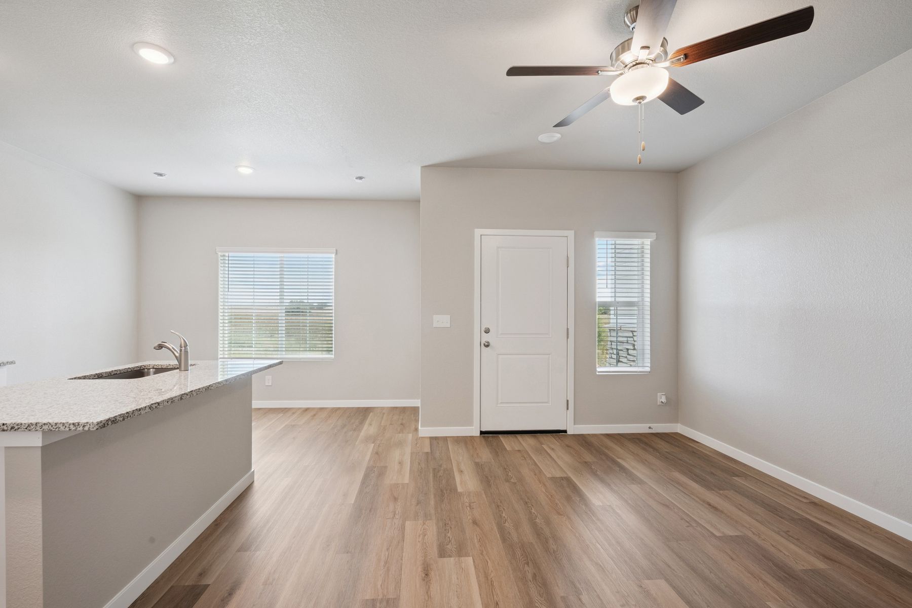 The family room is spacious with a ceiling fan.