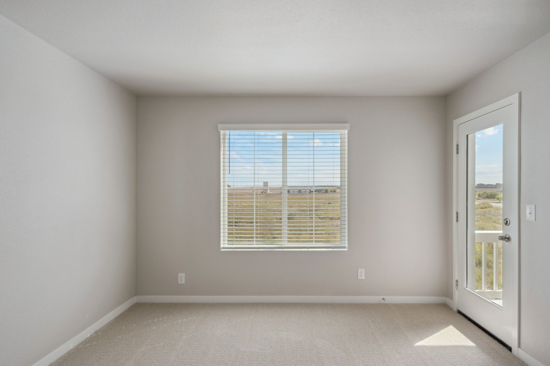 The master bedroom is spacious and has carpet.