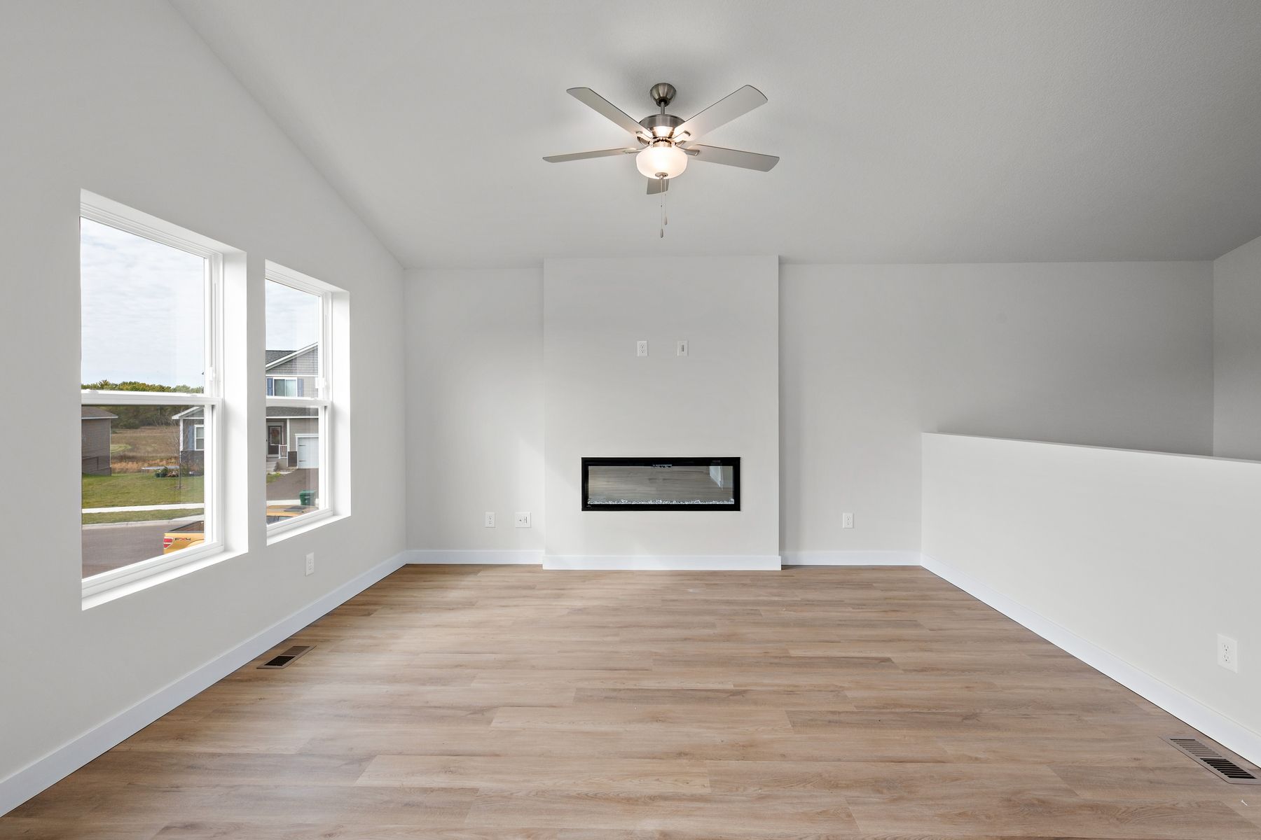 The family room is spacious with a ceiling fan.