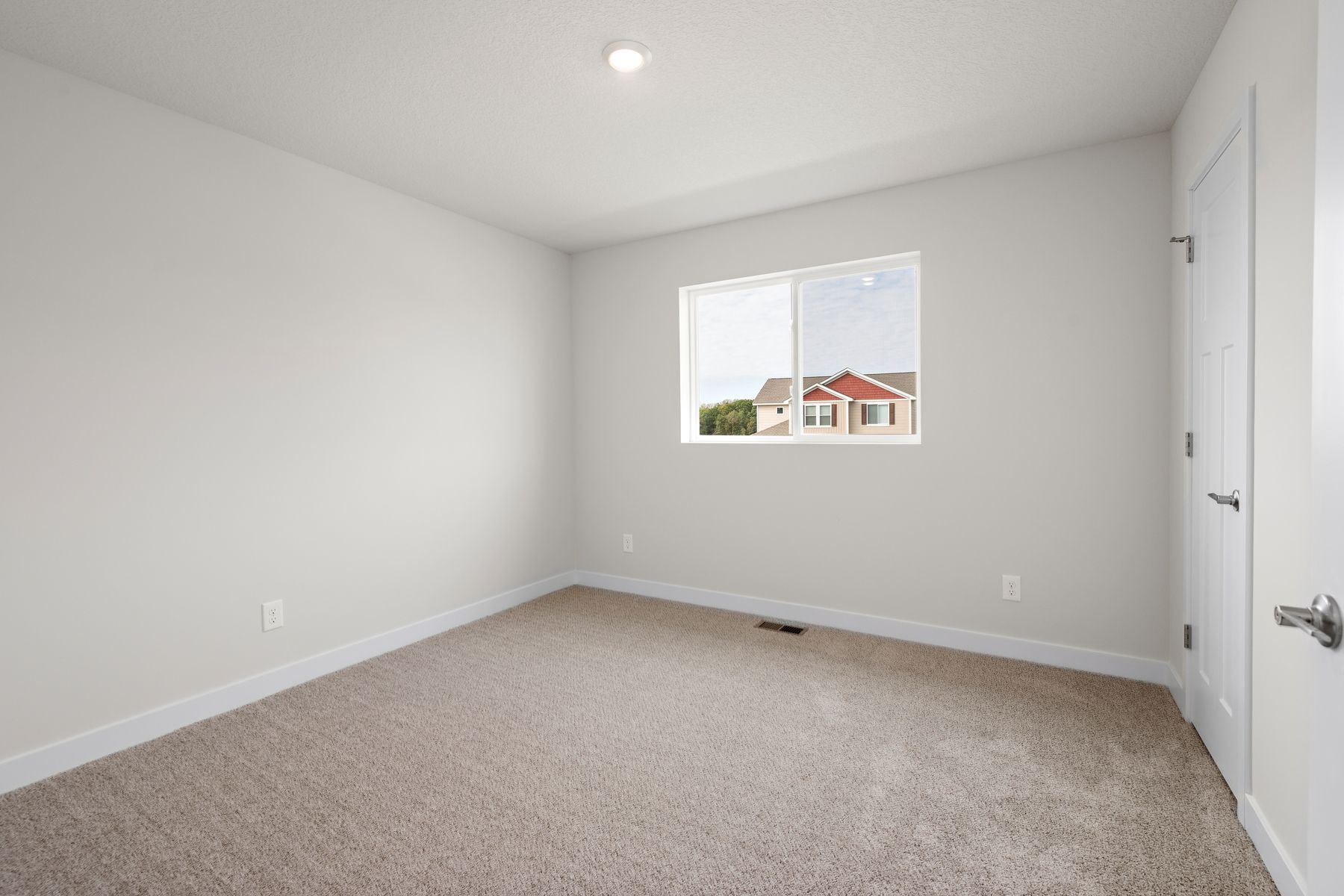 The master bedroom is spacious and has carpet.