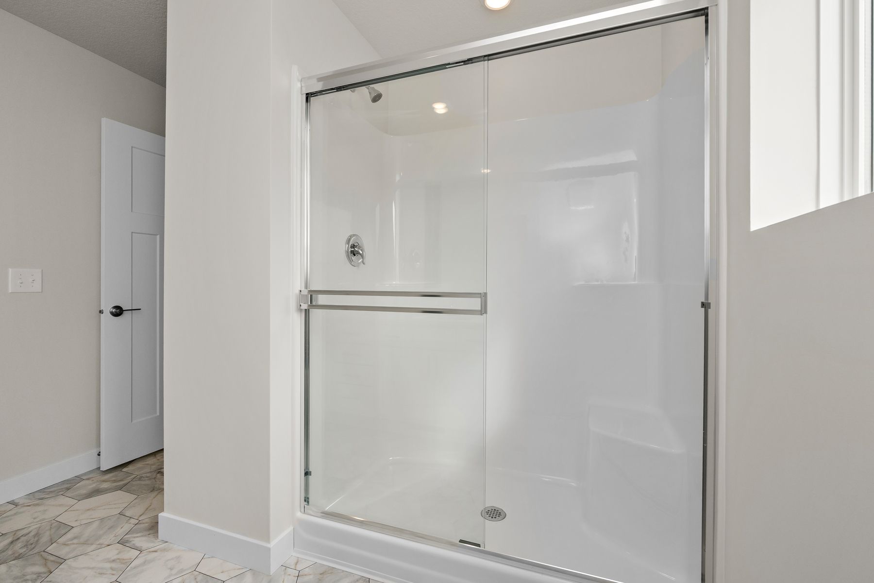 The master bathroom has a step in shower.