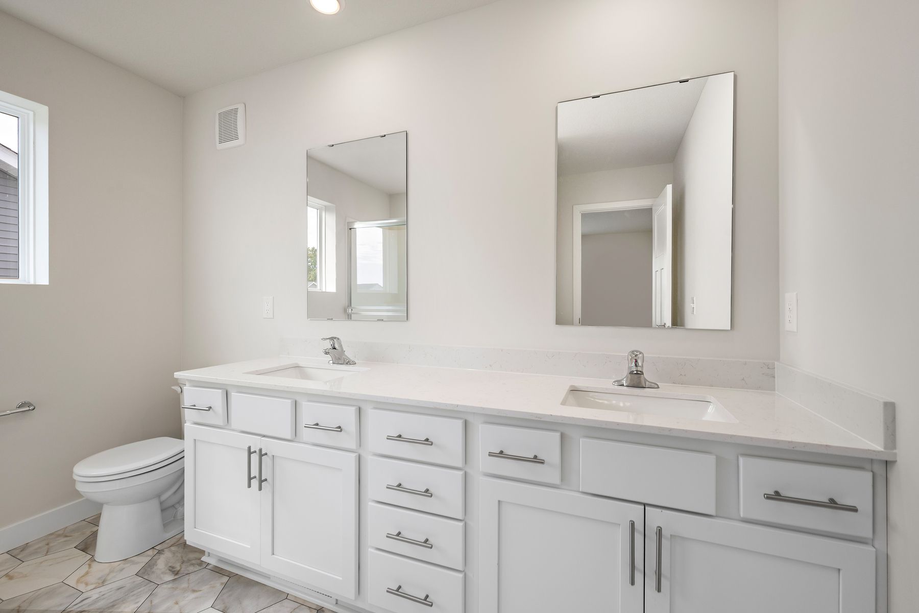 The master bathroom has a dual sink vanity.