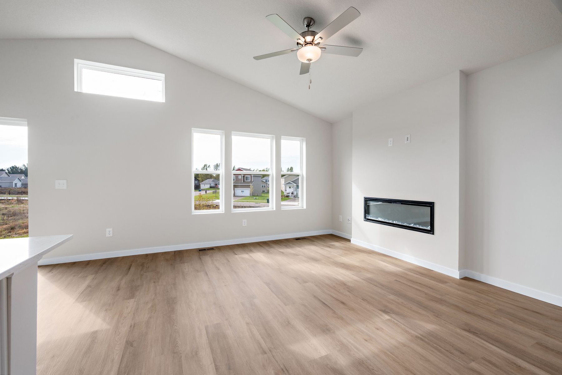 The family room is spacious with a ceiling fan.