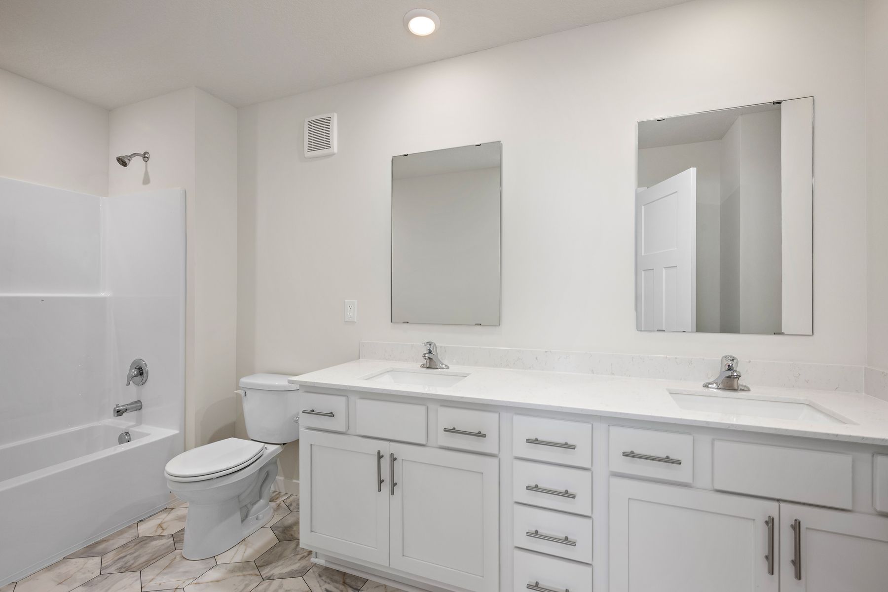 The master bathroom has a dual sink vanity.