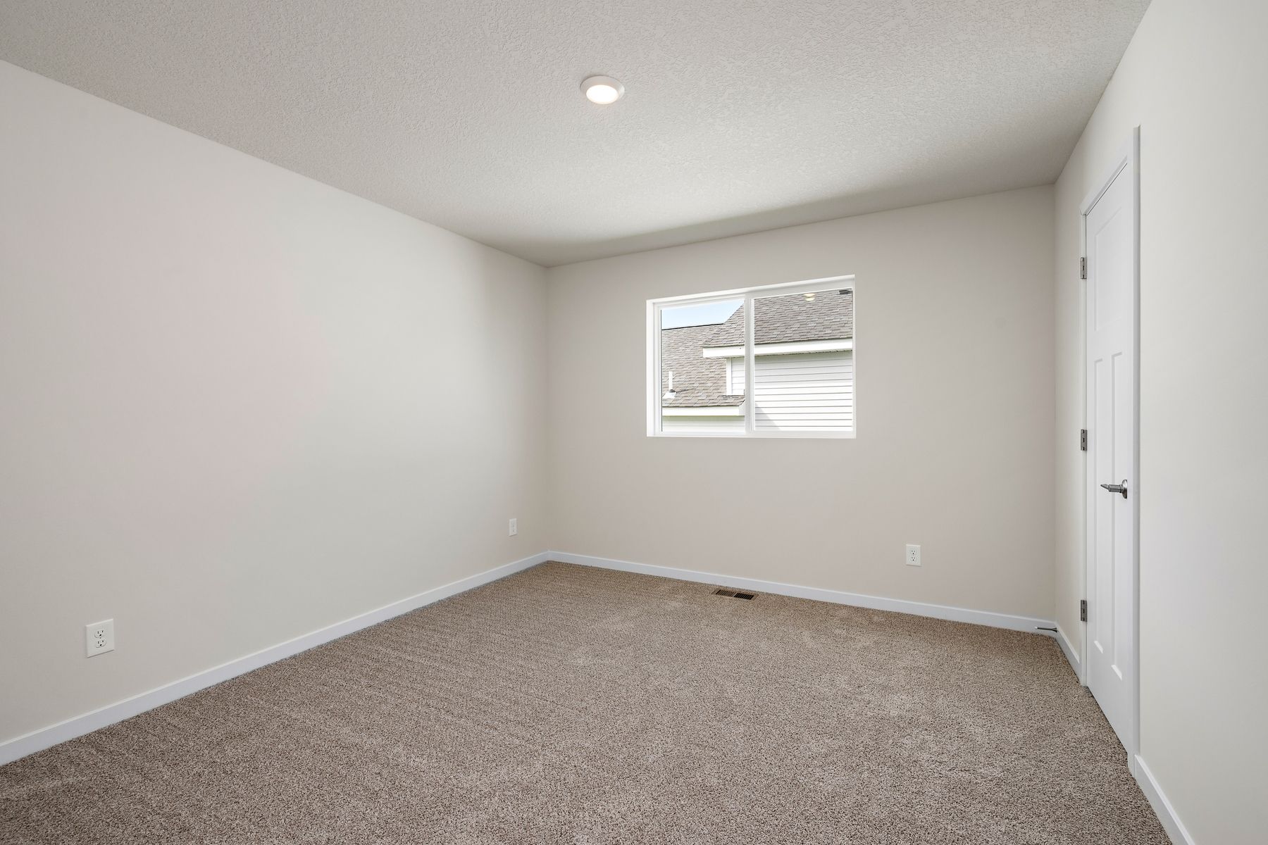 The master bedroom is spacious and has carpet.