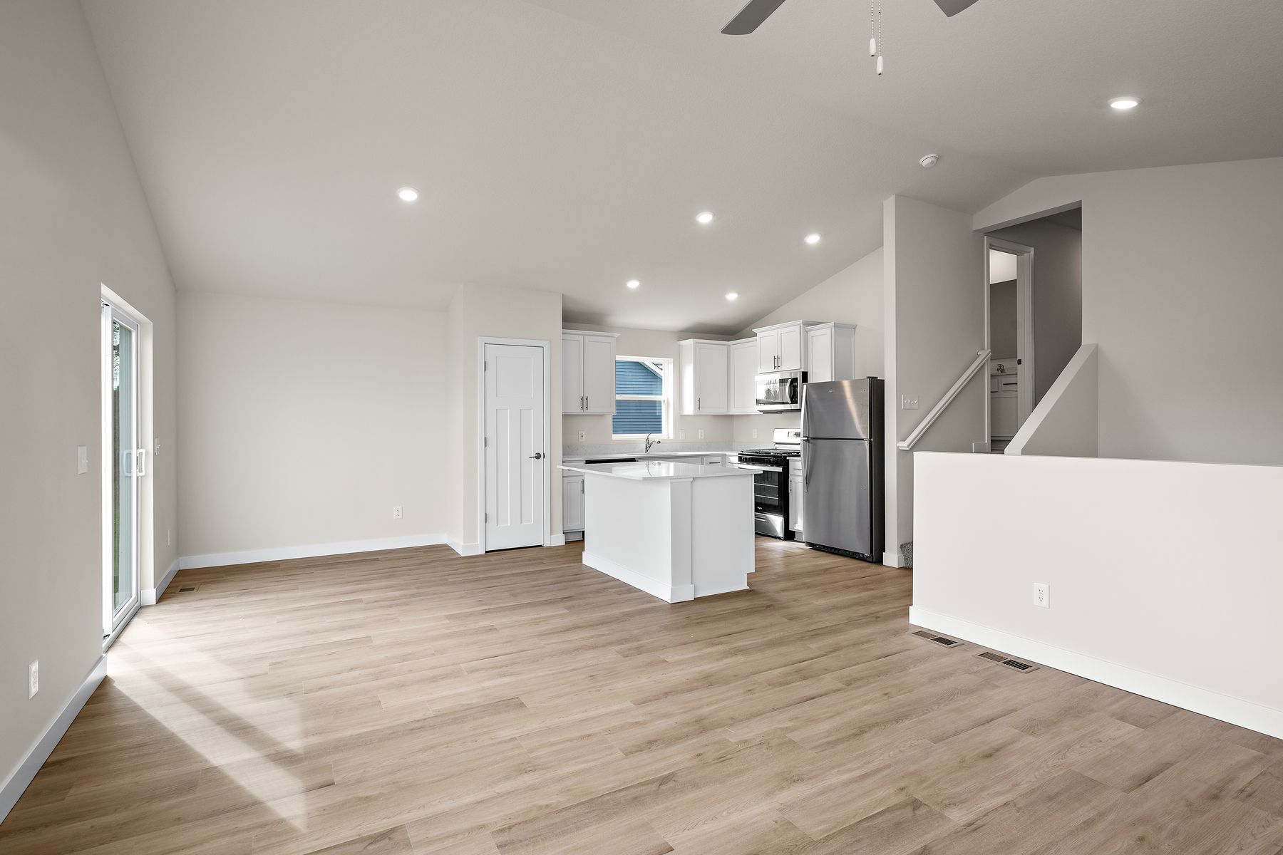 The family room is spacious with a ceiling fan.
