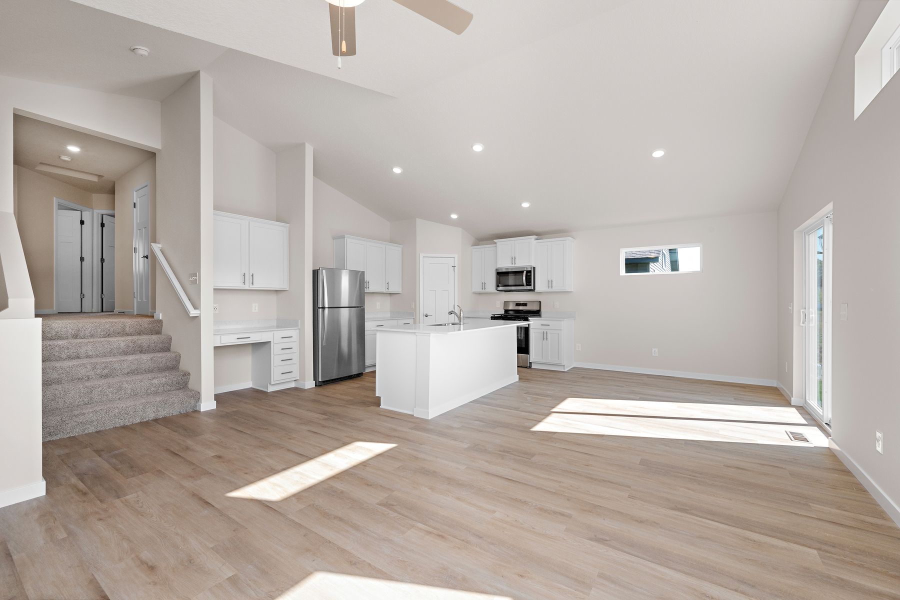 The family room is spacious with a ceiling fan.