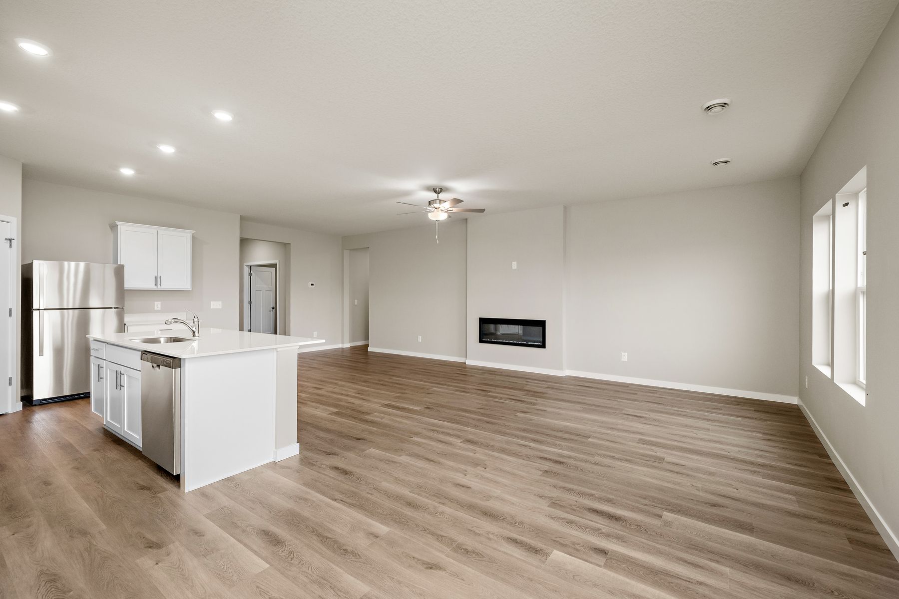The family room is spacious with a ceiling fan.