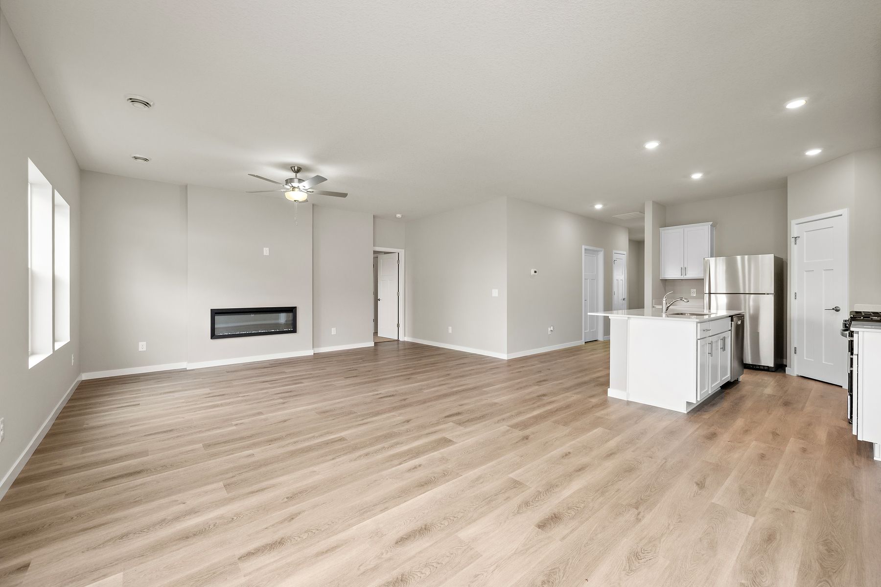 The family room is spacious with a ceiling fan.