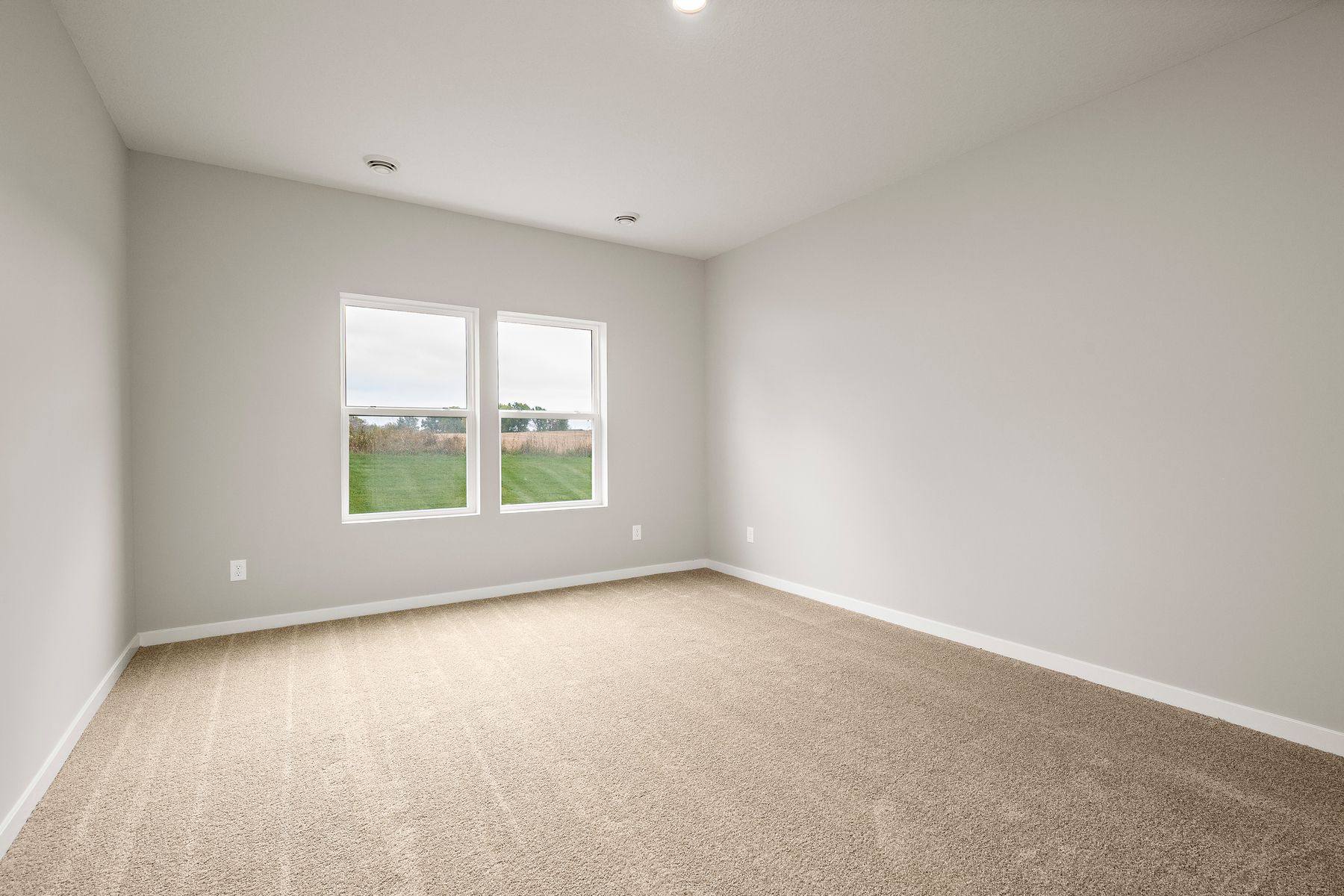 The master bedroom is spacious and has carpet.
