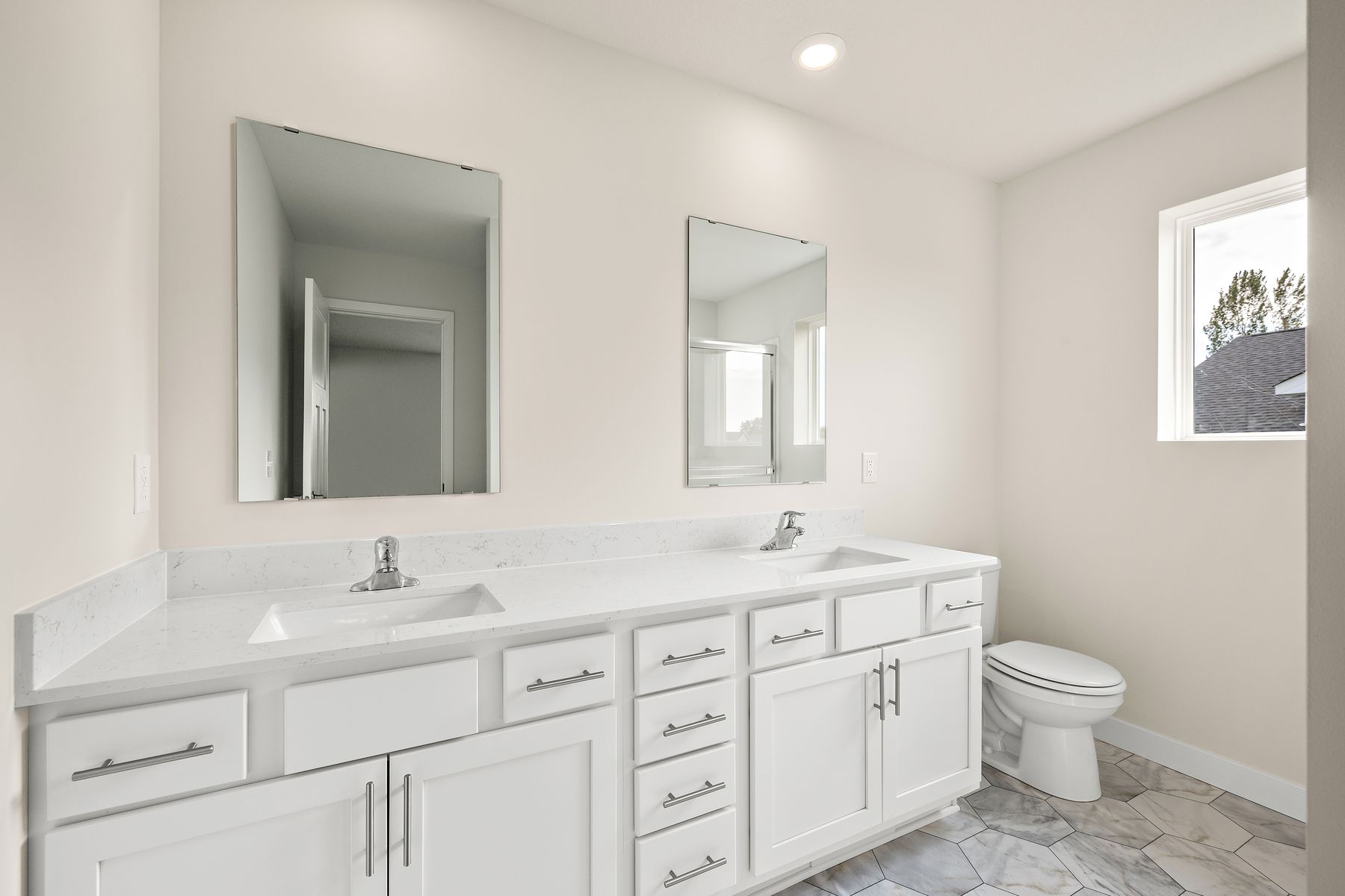 The master bathroom has a dual sink vanity and a step in shower.