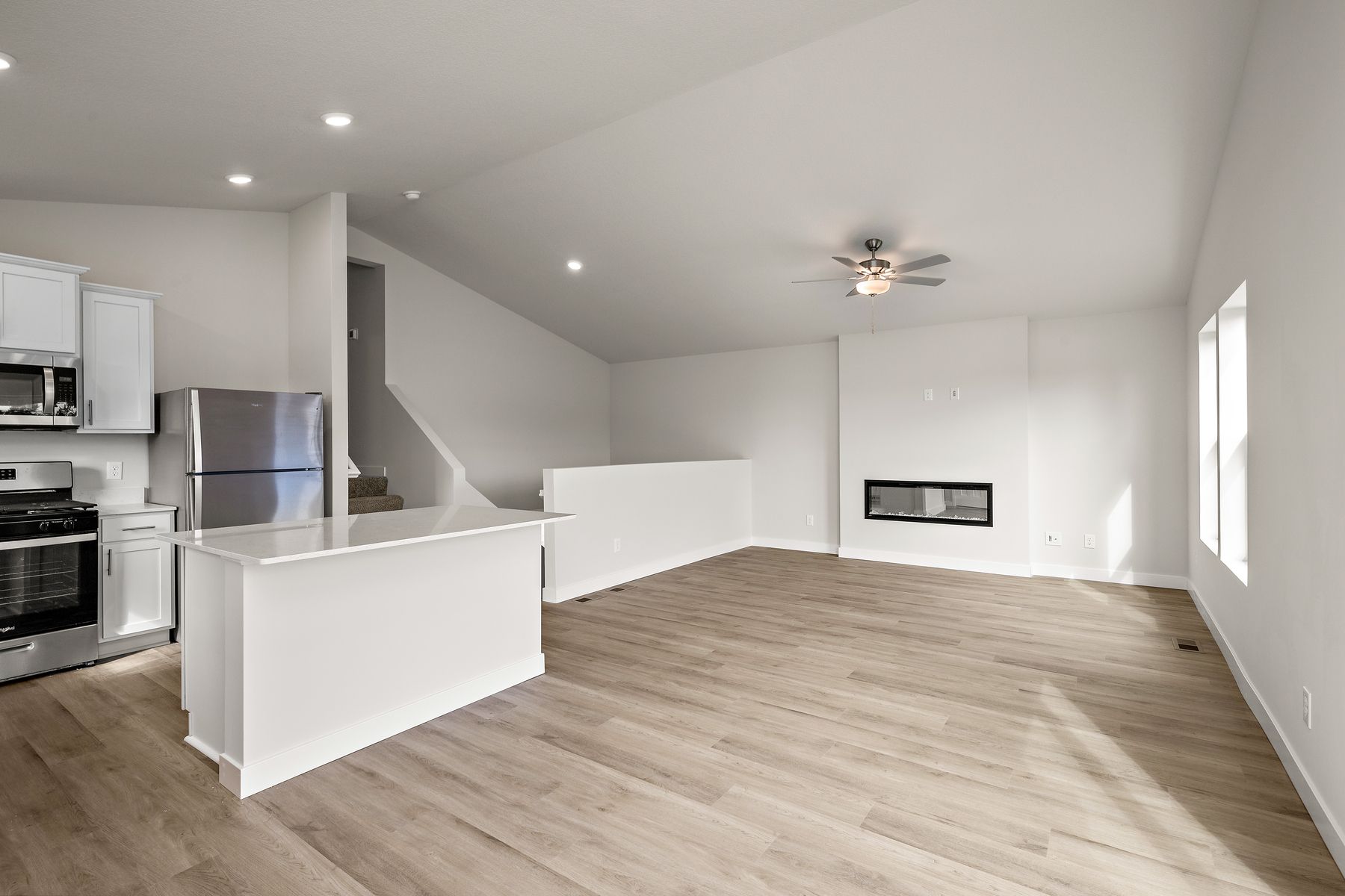 The family room is spacious with a ceiling fan.