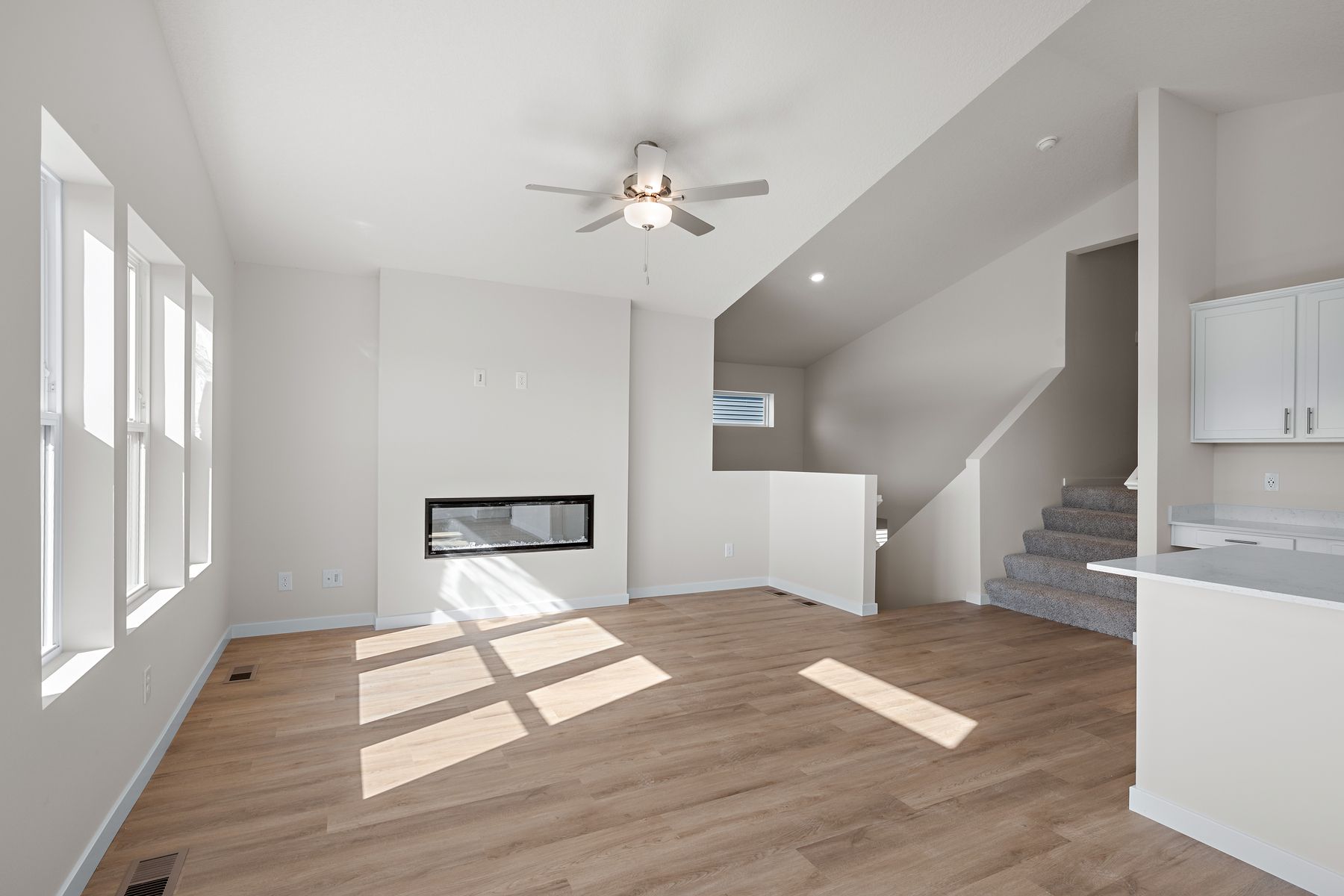 The family room is spacious with a ceiling fan.