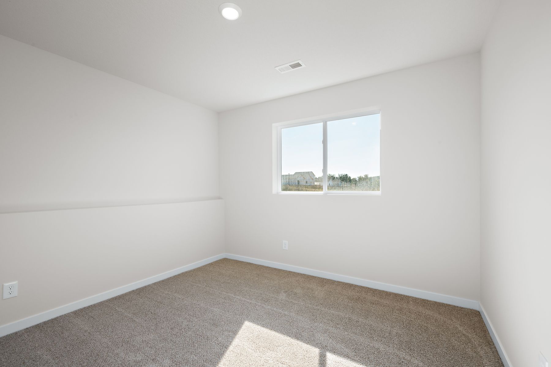 The master bedroom is spacious and has carpet.