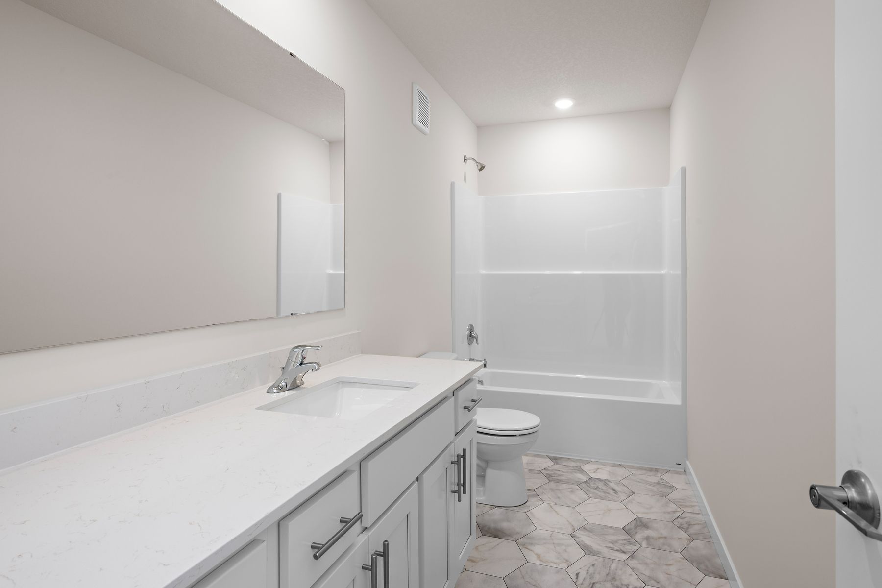 The master bathroom has a large vanity.