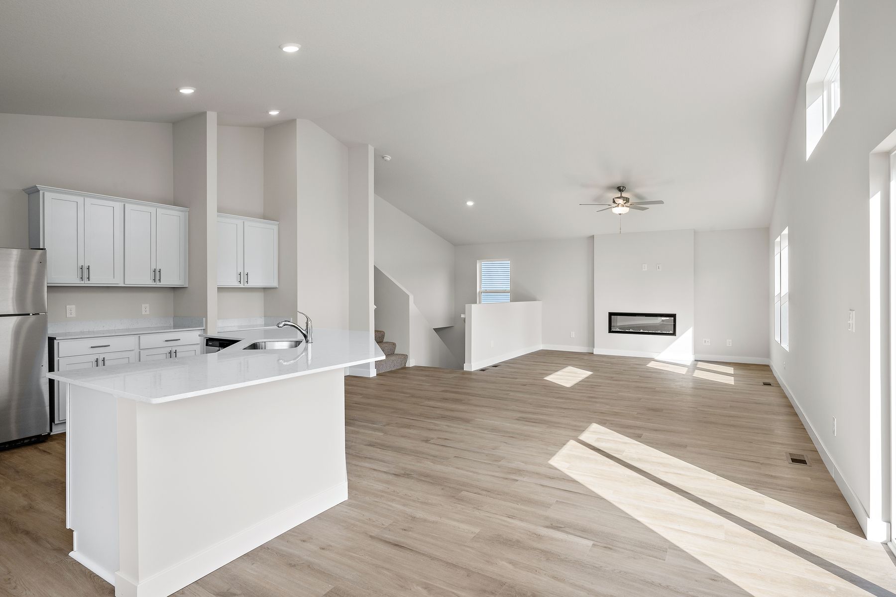The family room is spacious with a ceiling fan.'