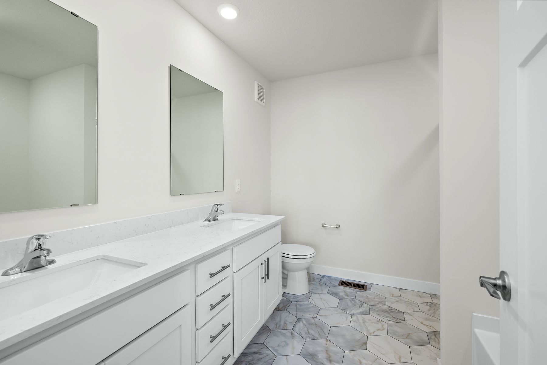The master bathroom has a dual sink vanity.