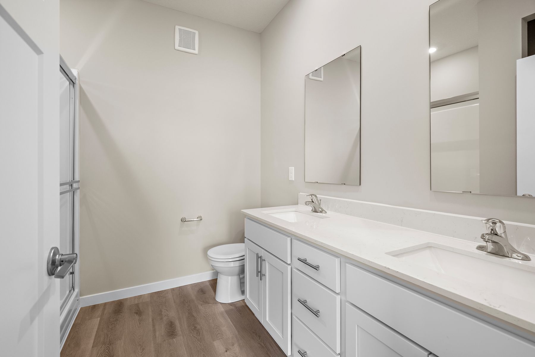 The master bathroom has a dual sink vanity.