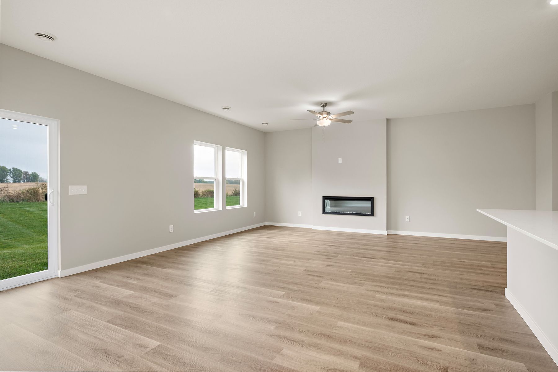 The family room is spacious with a ceiling fan.