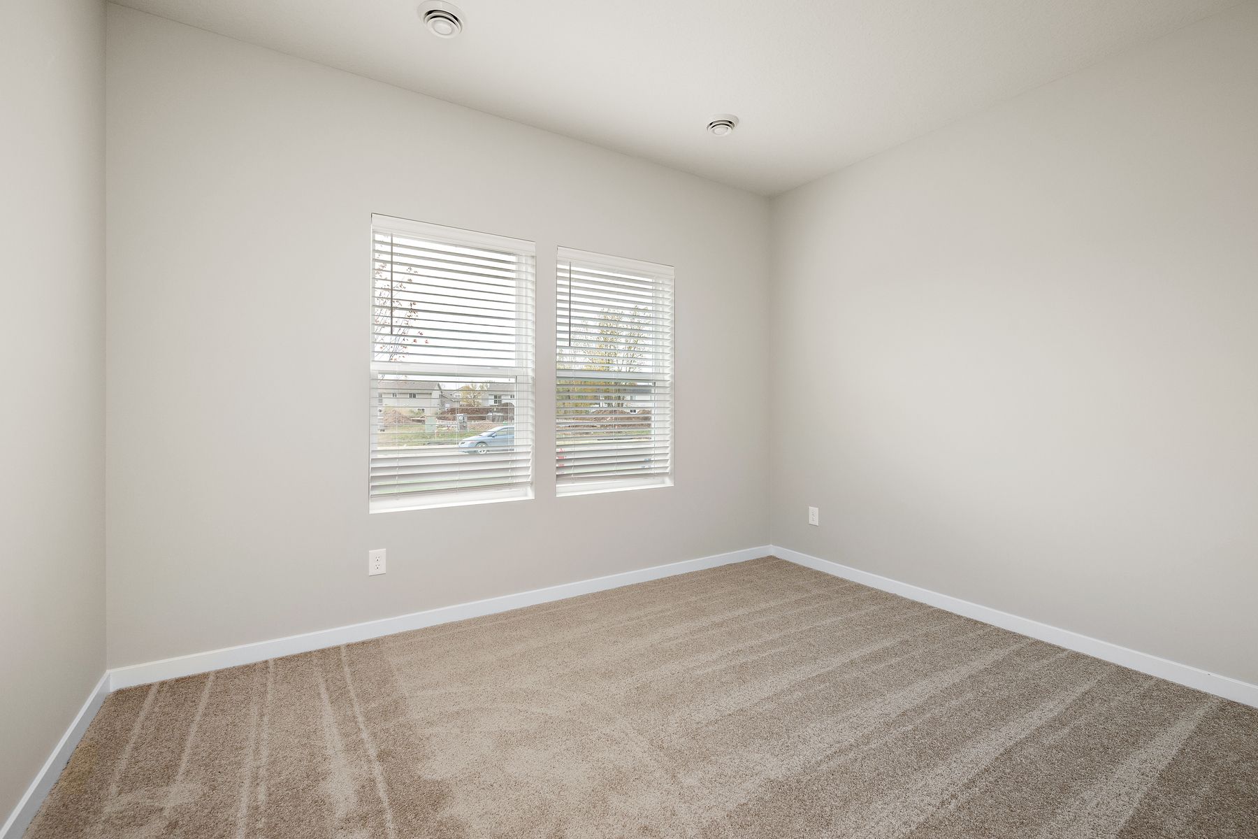 The master bedroom is spacious and has carpet.
