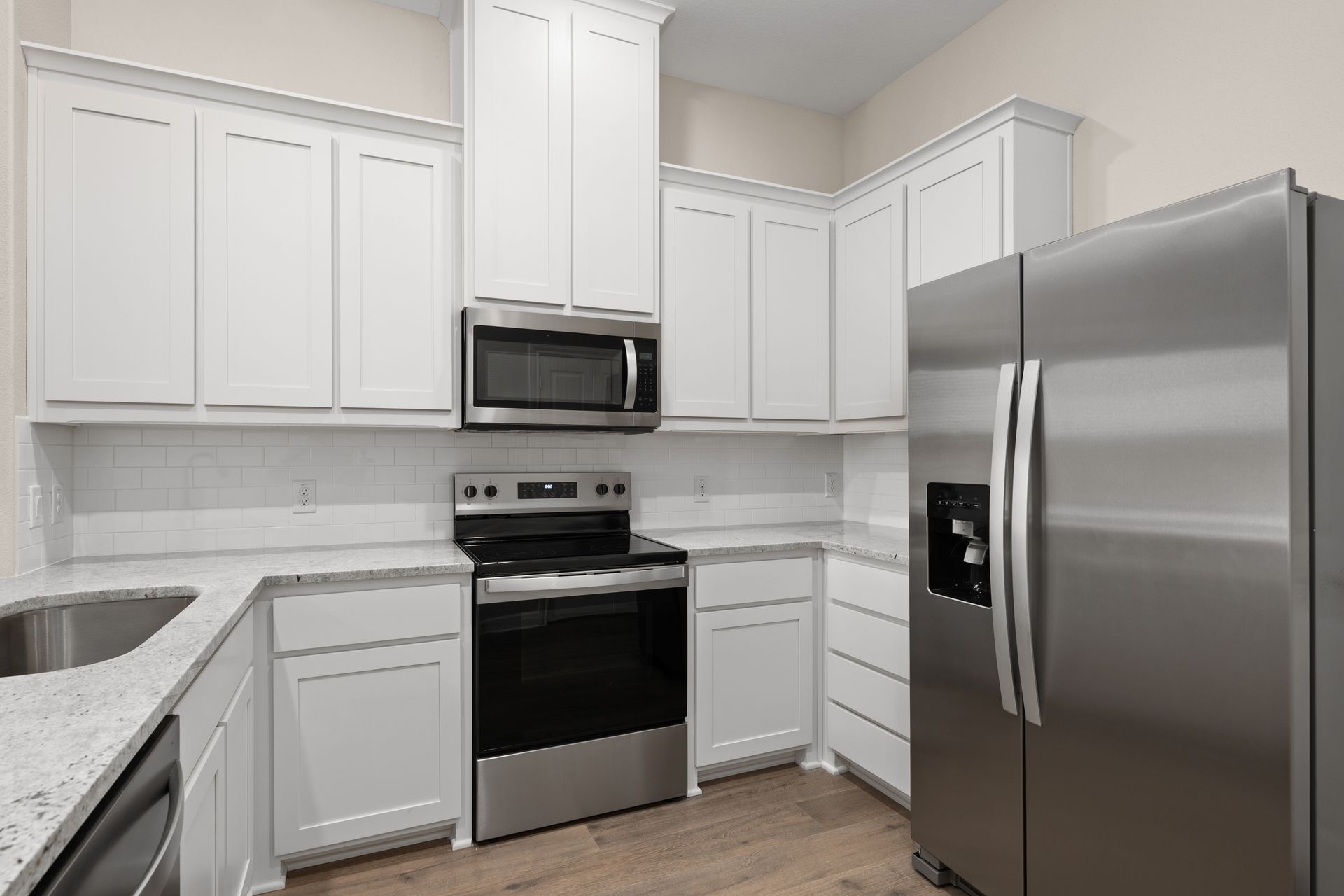The kitchen has a beautiful tile backsplash.
