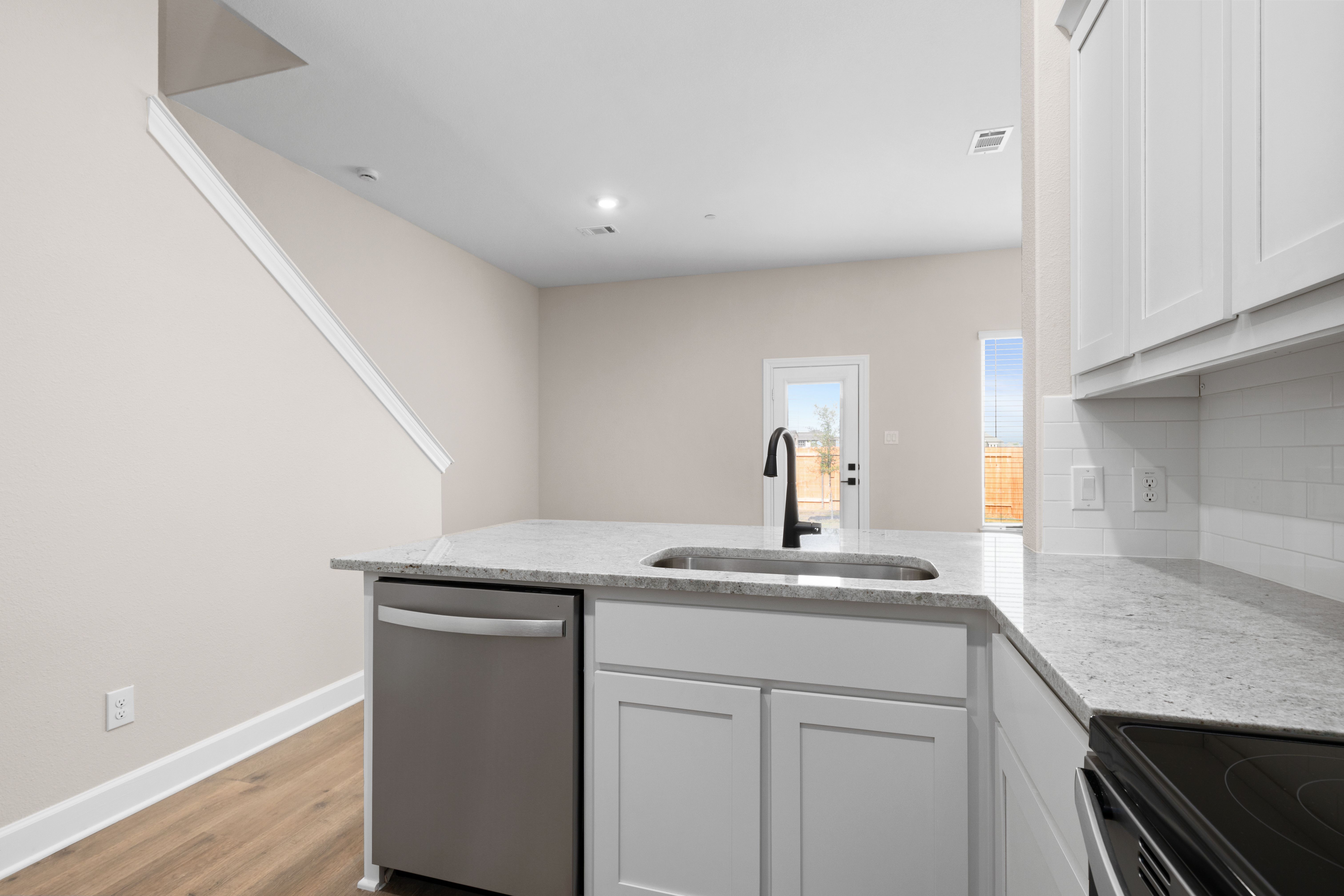 The kitchen looks out to the dining area.