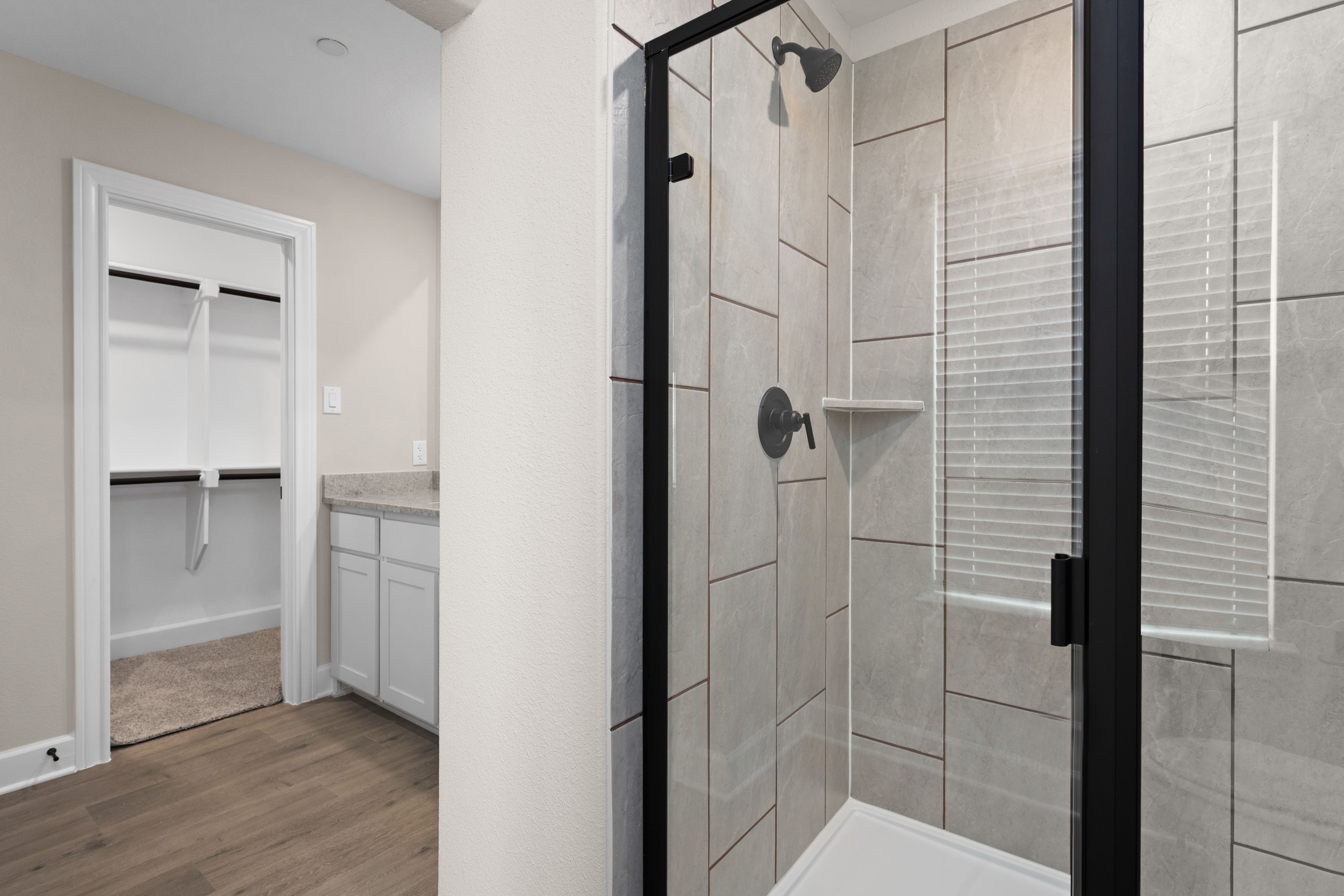 The master bathroom has a glass, walk-in shower.