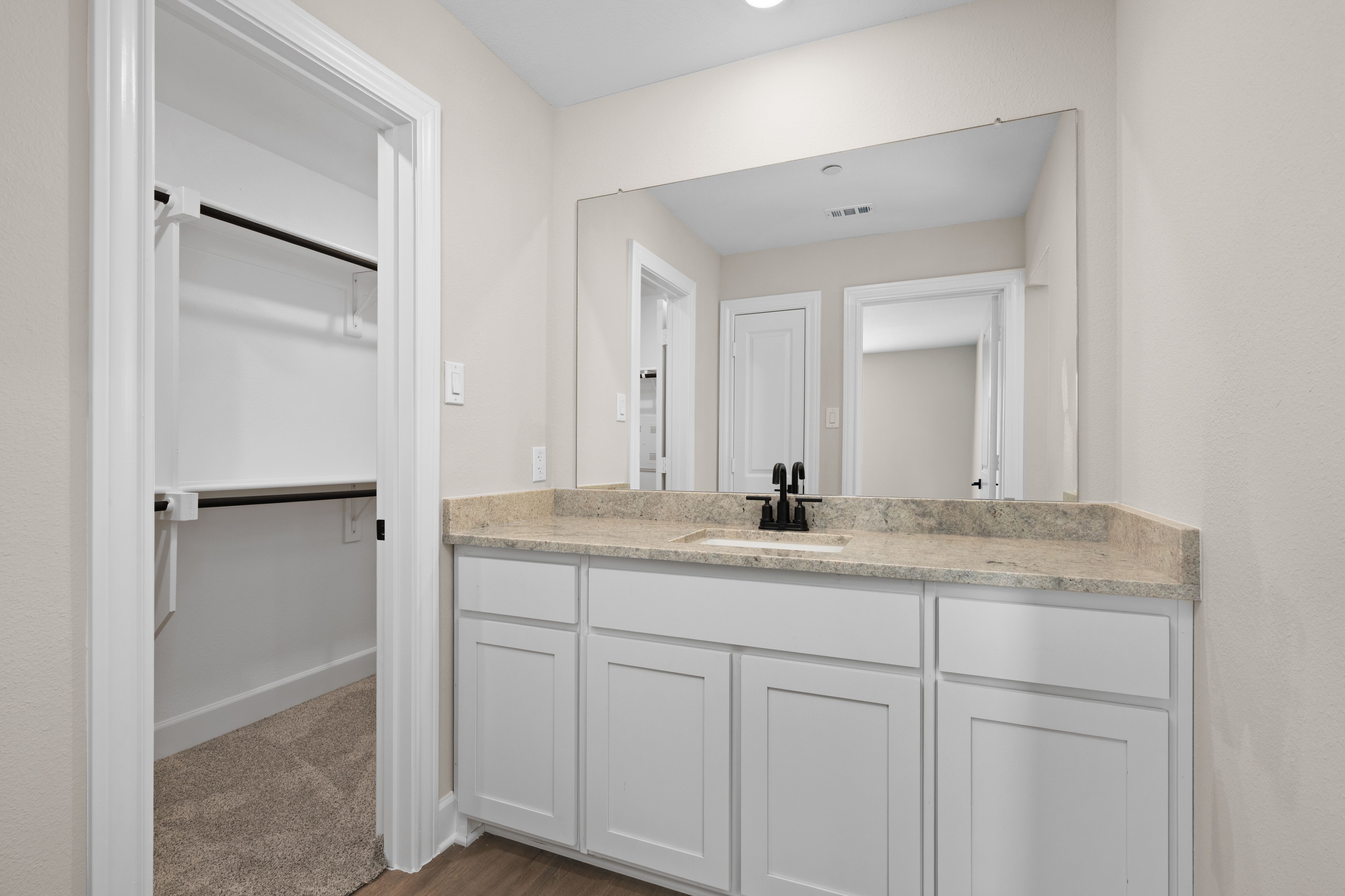 The master bathroom has a sprawling vanity.