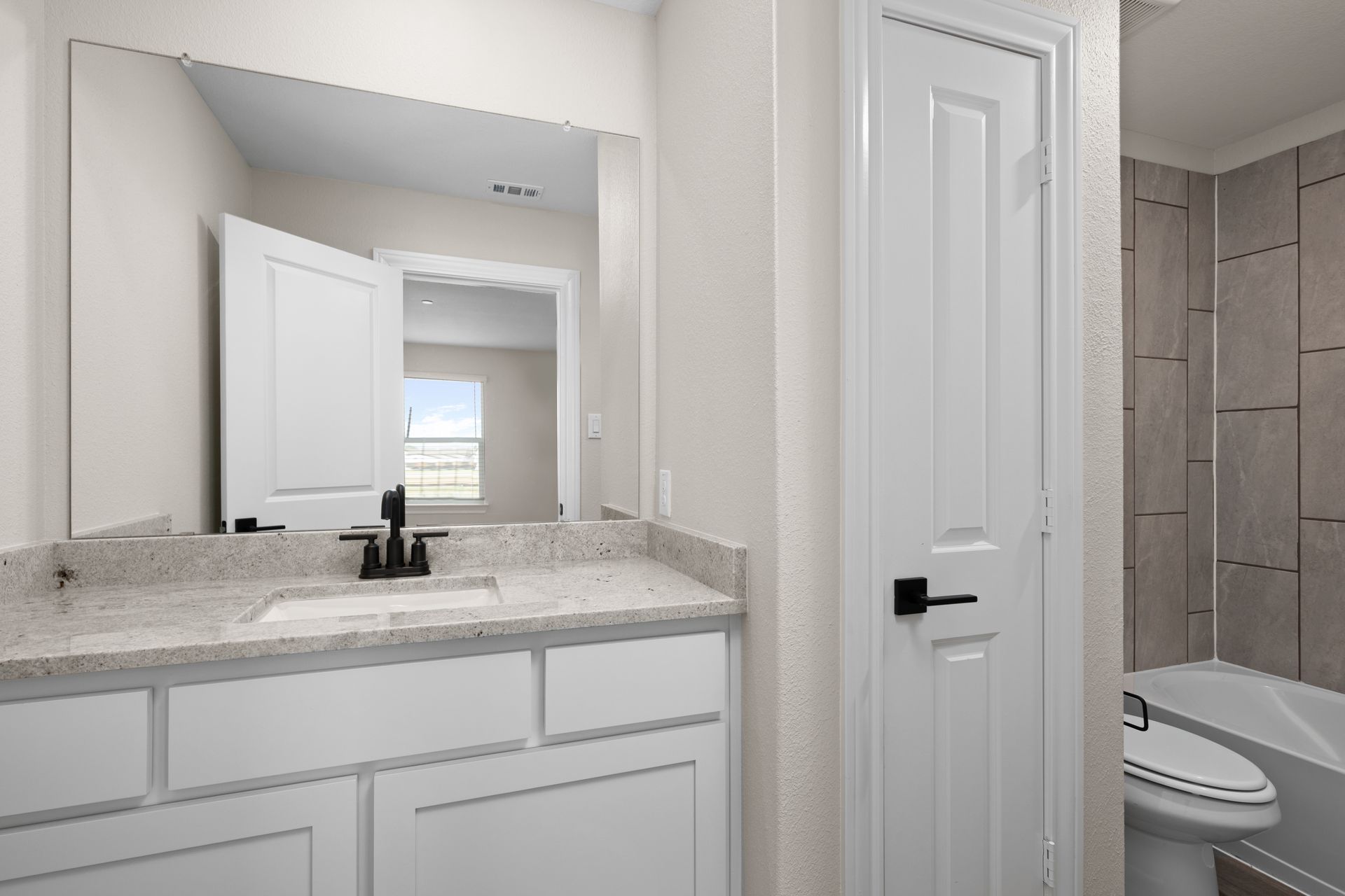 The secondary bathroom has a sprawling vanity.