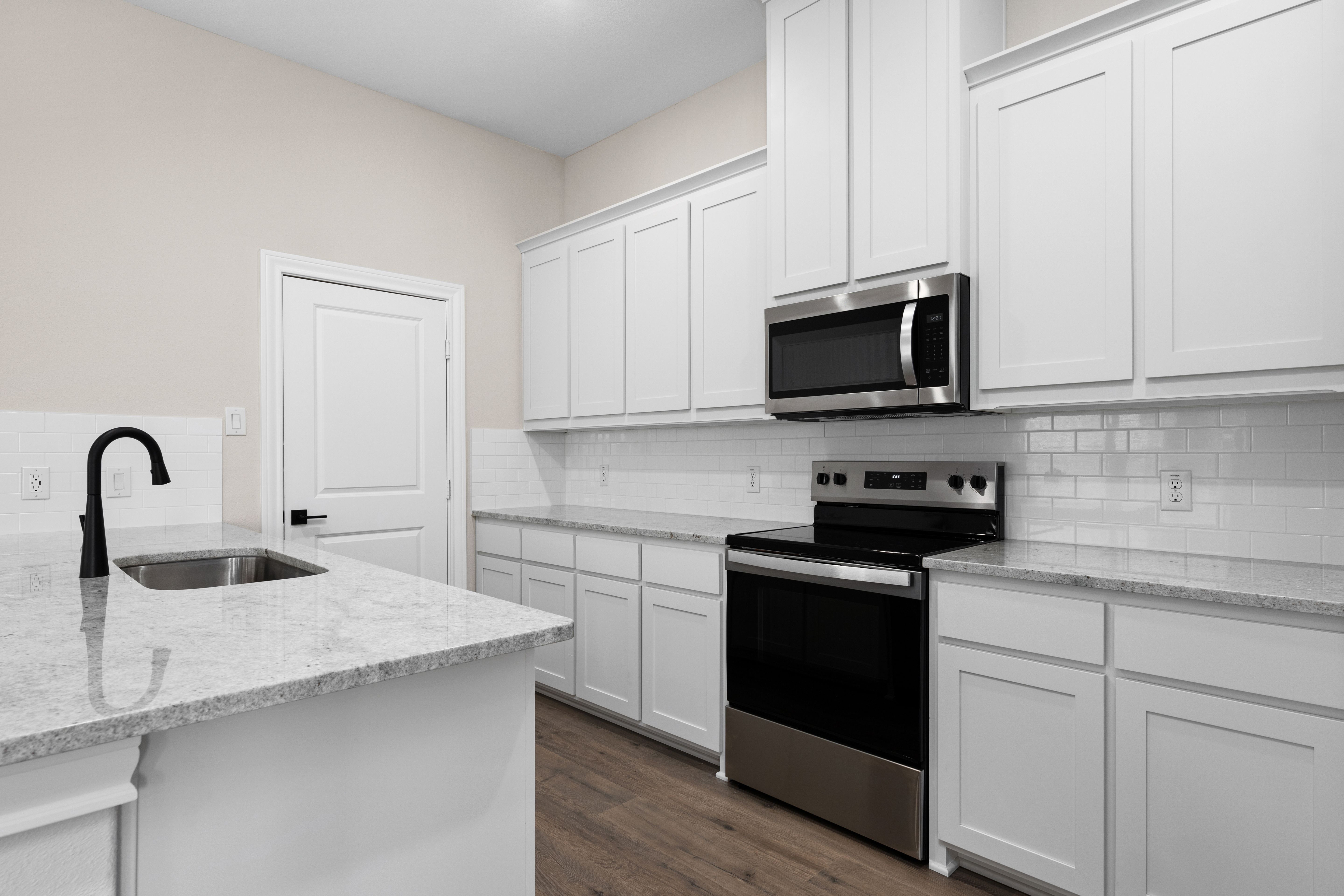 The kitchen has a beautiful tile backsplash.