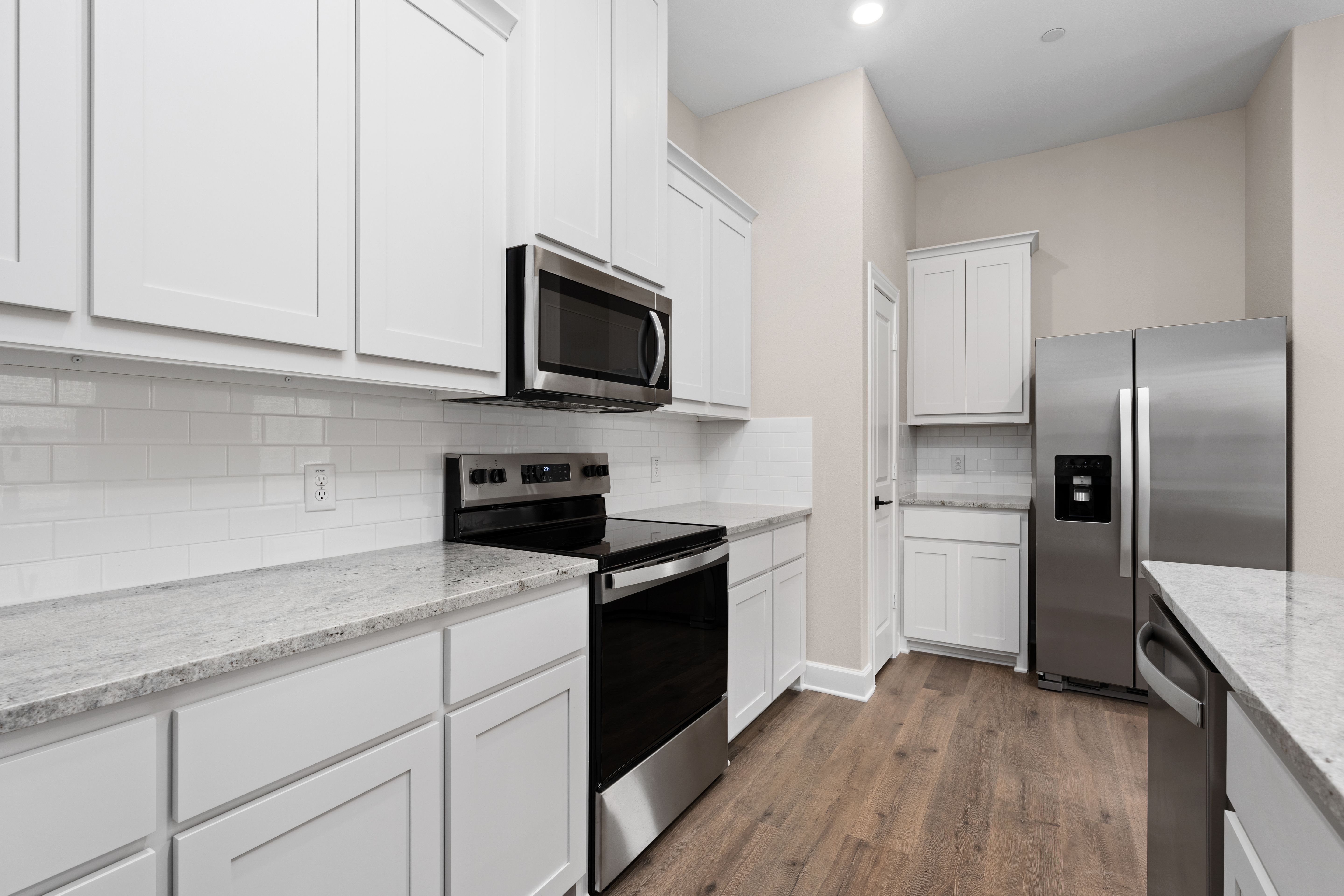 The kitchen has sprawling granite countertops.
