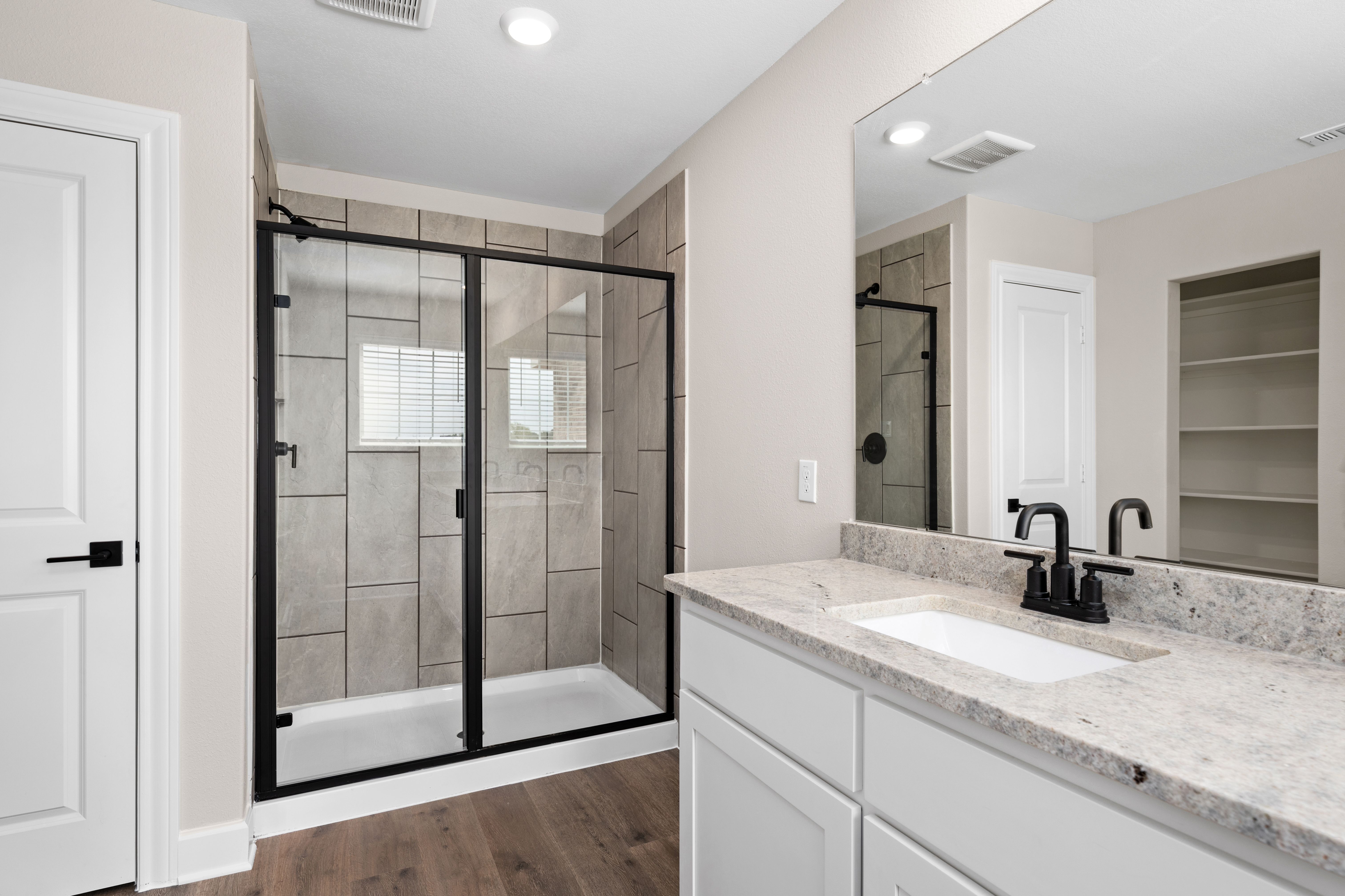 The master bathroom has a glass, walk-in shower.