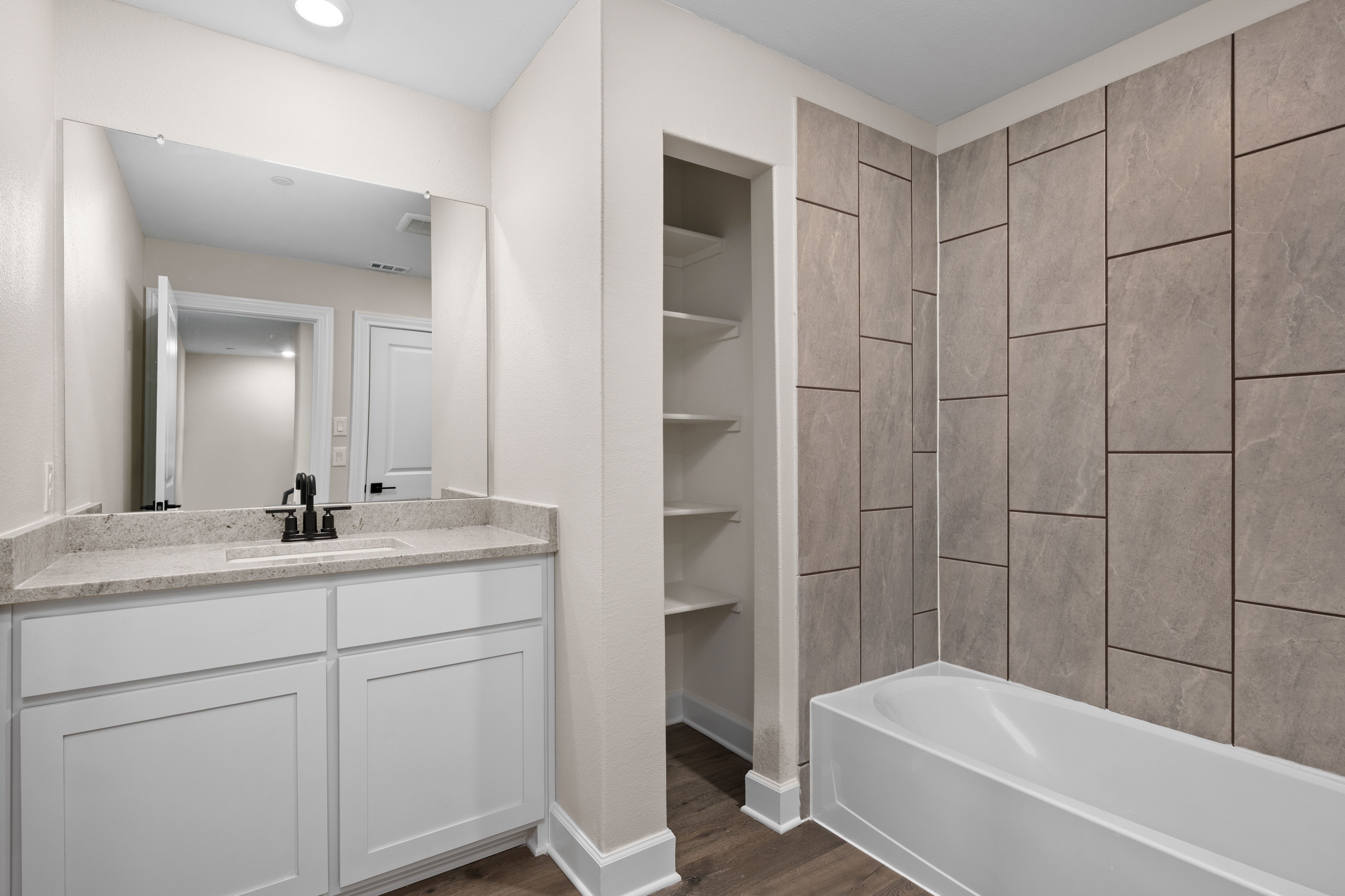 The secondary bathroom has a large vanity space.