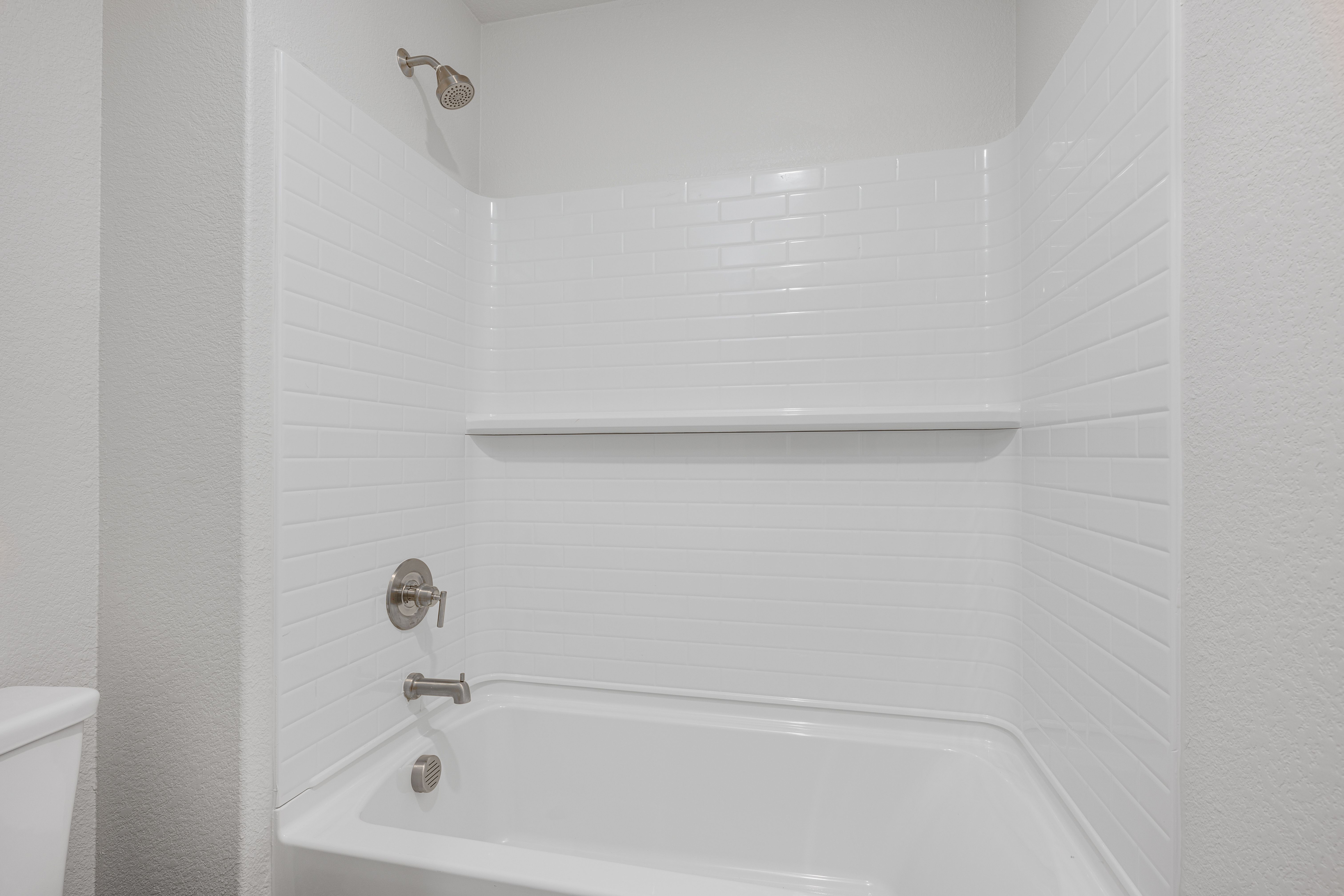 The secondary bathroom has a shower-tub combo.