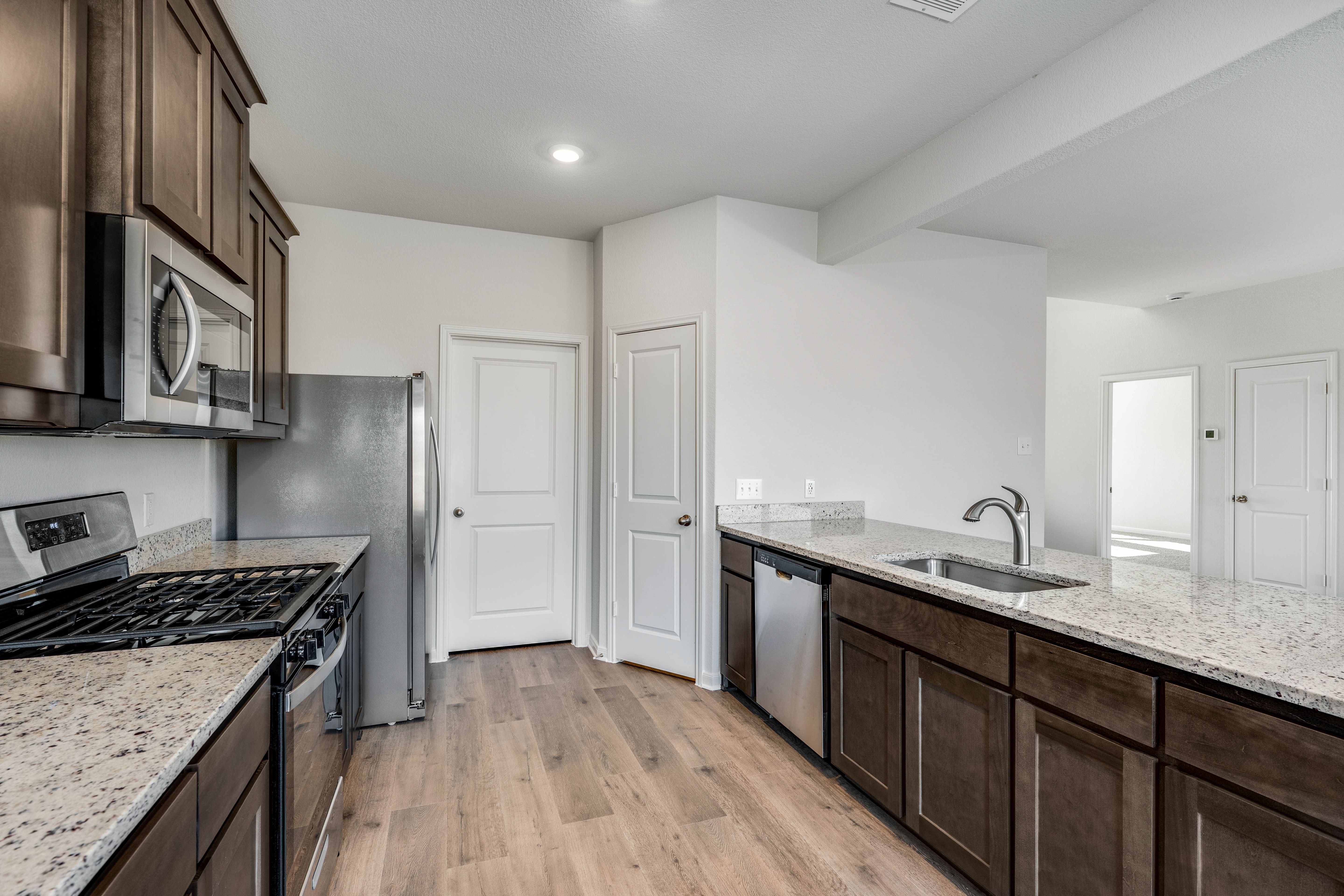 The kitchen has beautiful wood cabinetry.