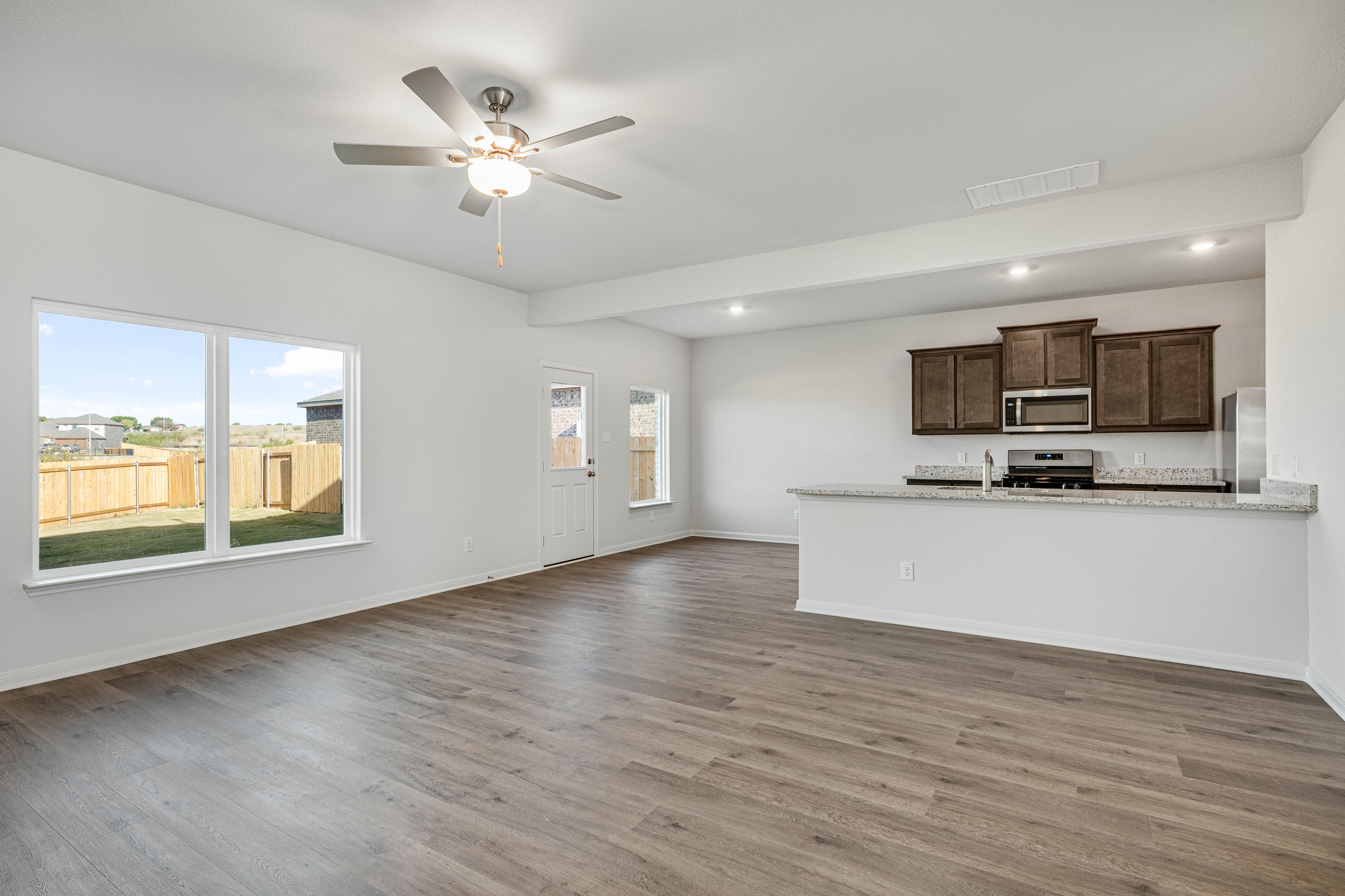 The kitchen, dining room and family room sit adjacent to one another.