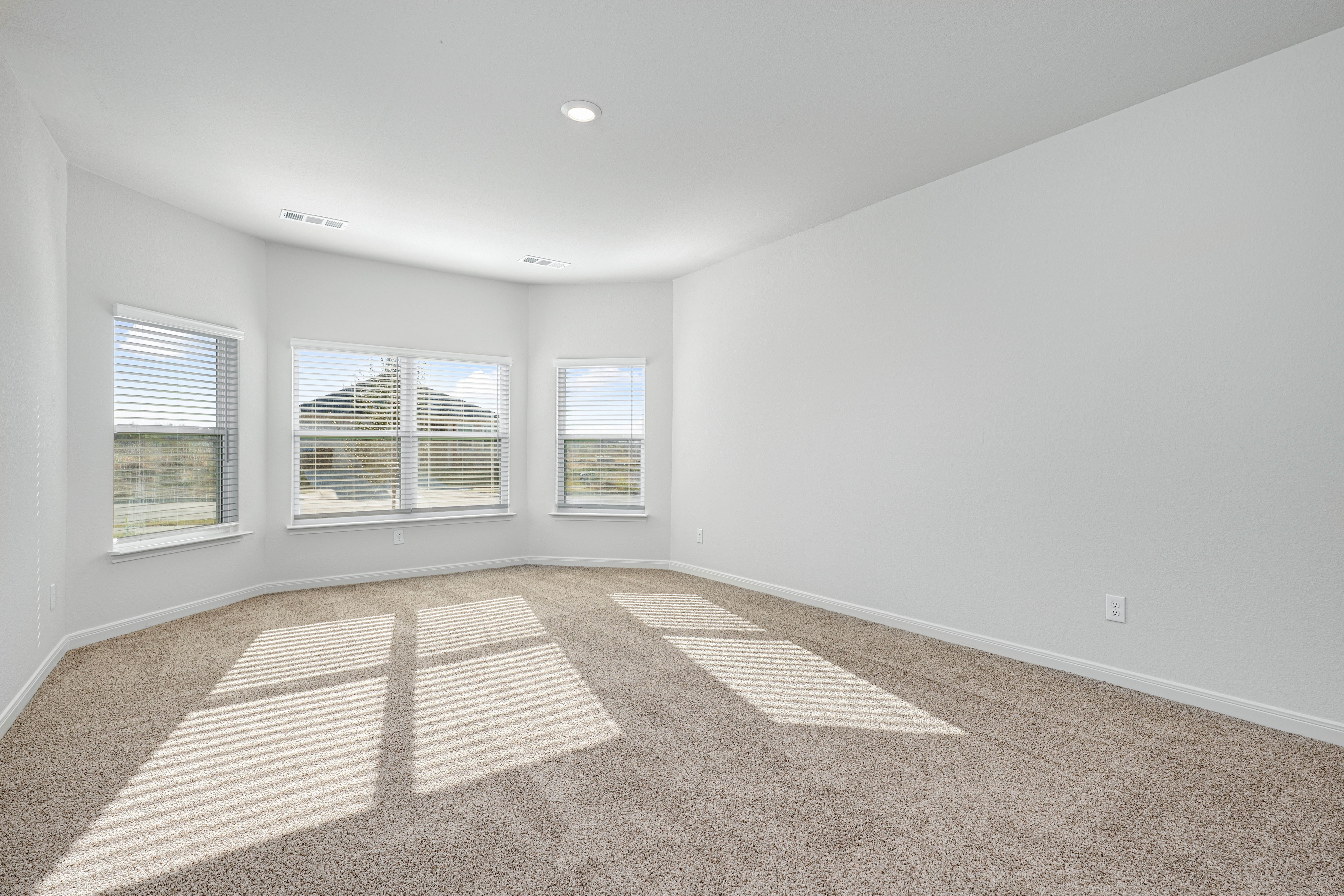 The master bedroom has three large windows that let in great, natural light.