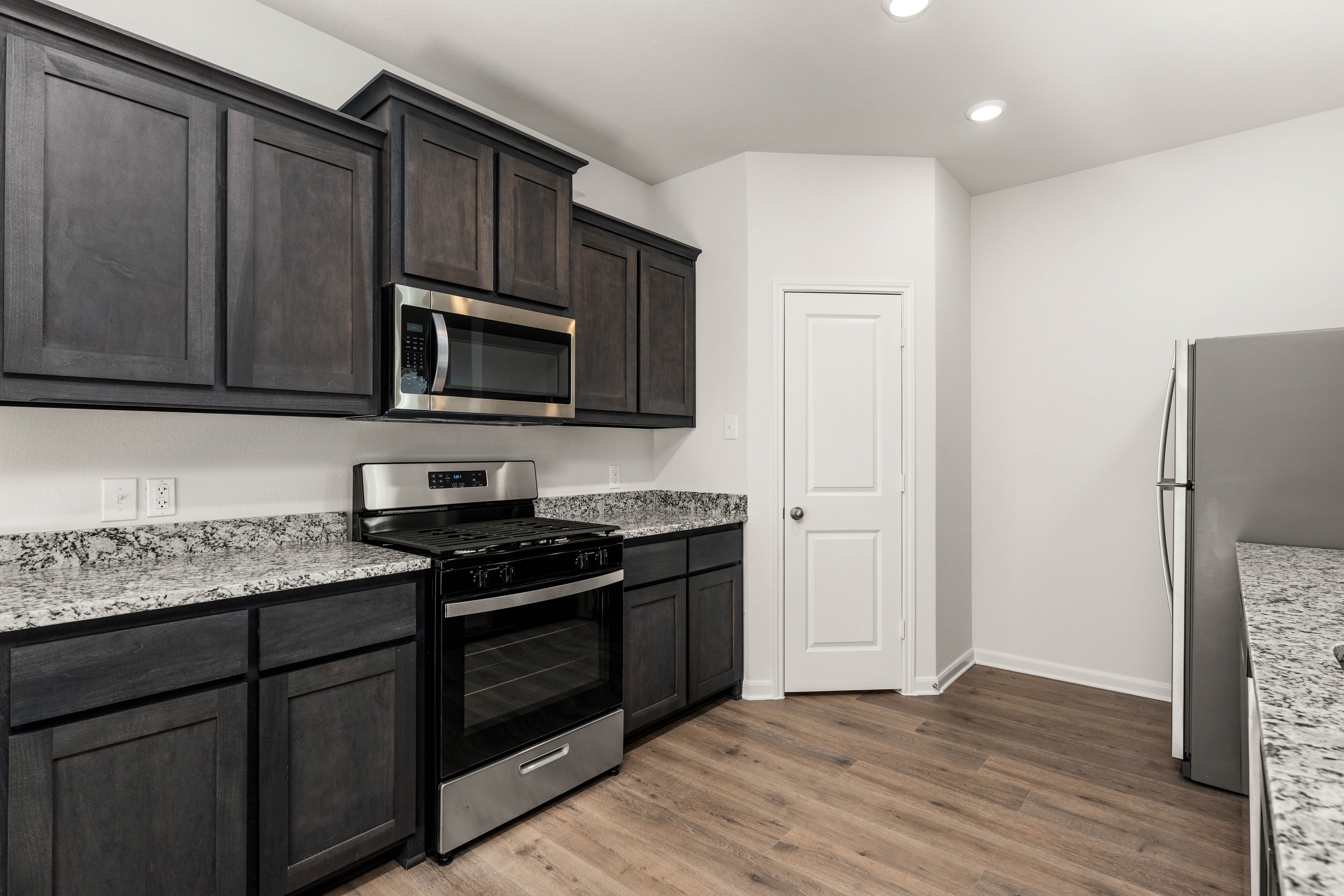 The kitchen of the Reed has beautiful wood cabinetry.